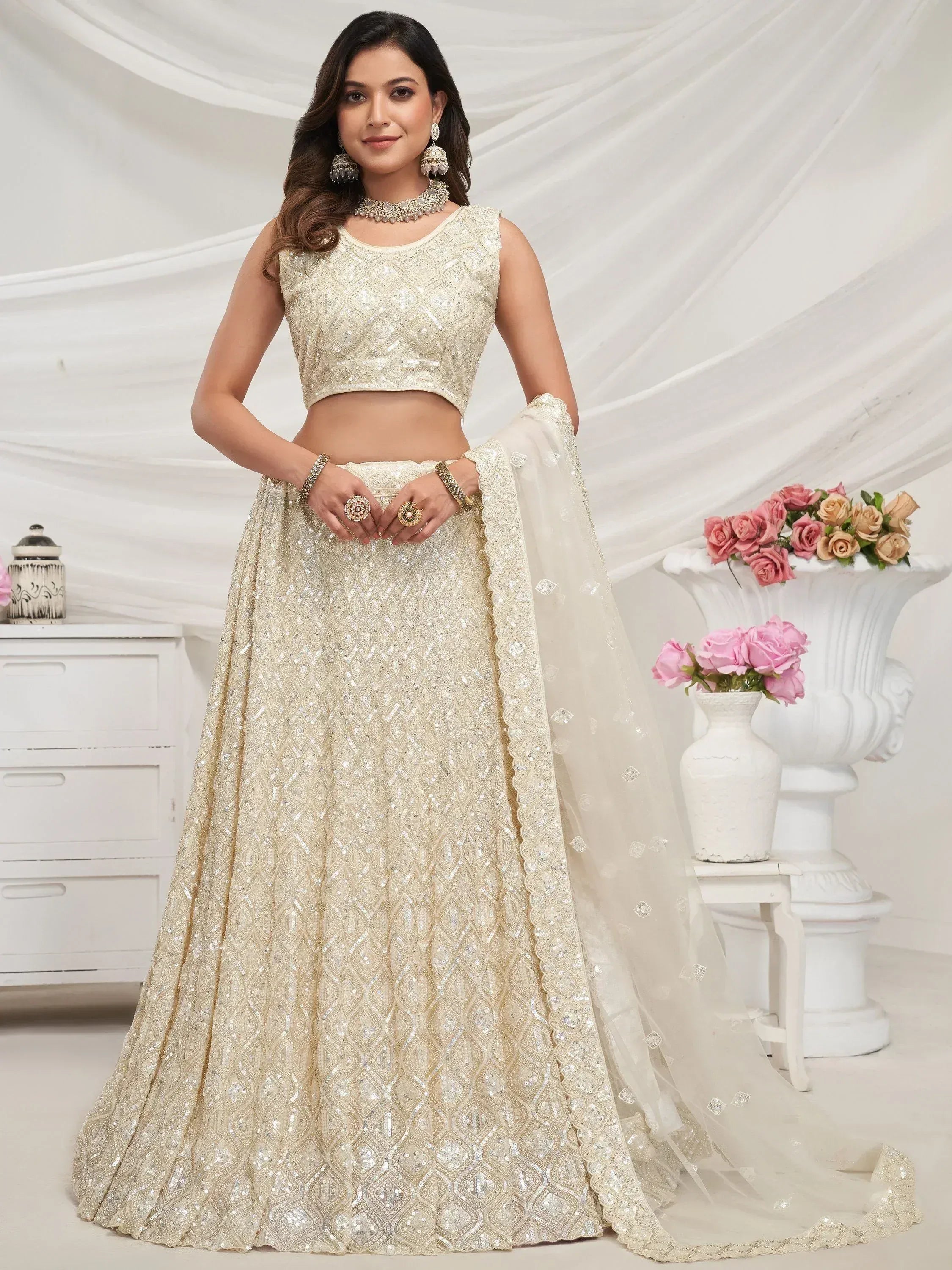 Elegant ivory designer lehenga choli with intricate sequin work, perfect for weddings and festive occasions.