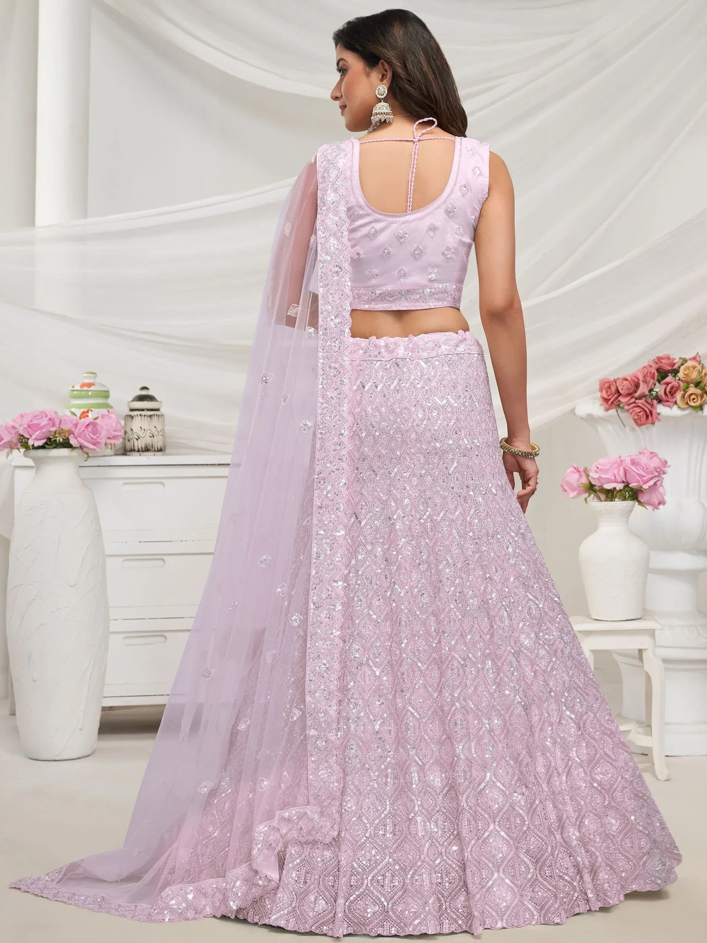 Light pink designer lehenga choli with sequin work and sheer dupatta, perfect for weddings and festive occasions.