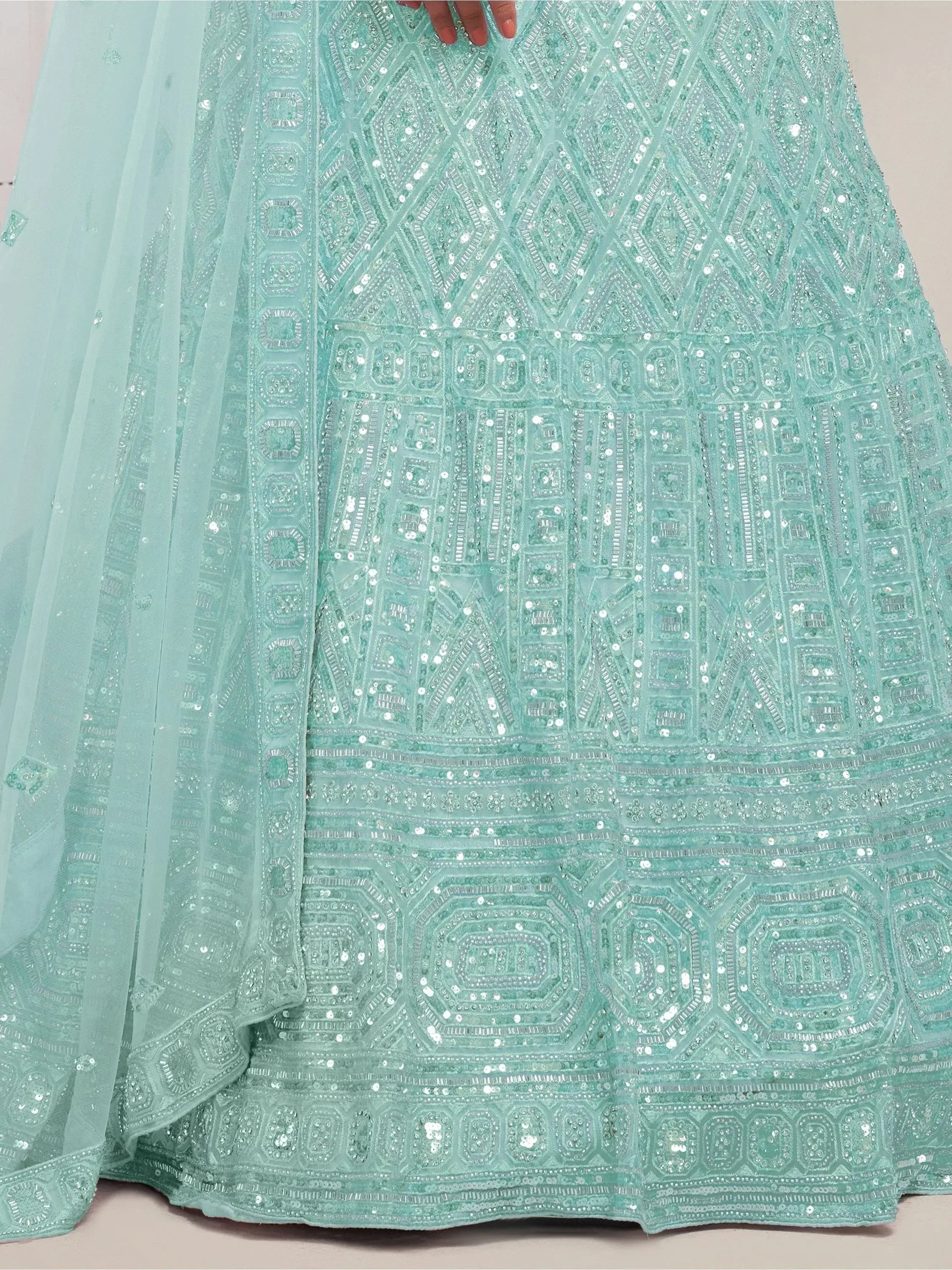Mint green embroidered lehenga with intricate geometric sequin patterns and sheer dupatta, perfect for Indian ethnic wear.