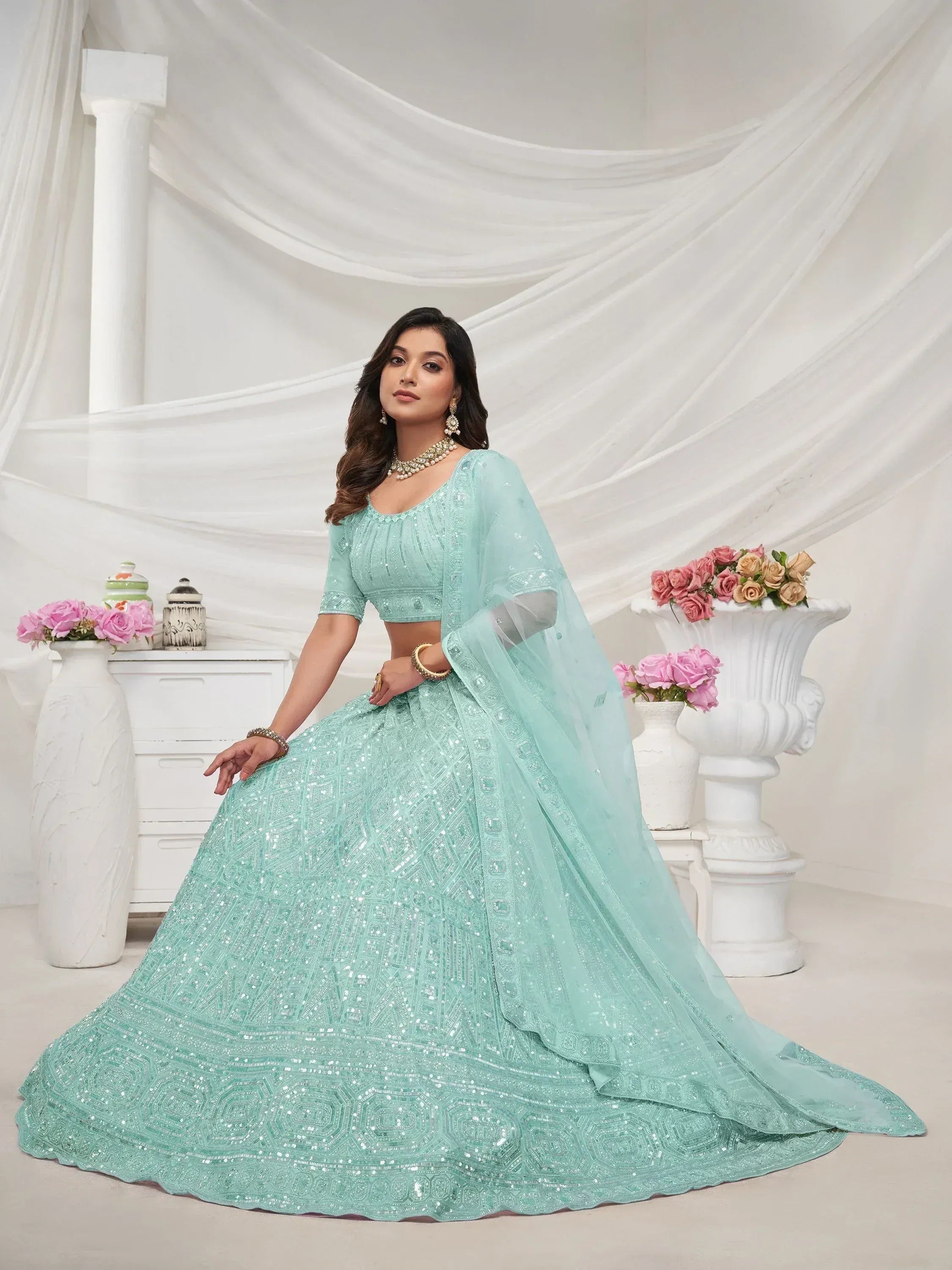 Mint green designer lehenga choli with intricate sequin work, perfect for weddings and festive occasions.