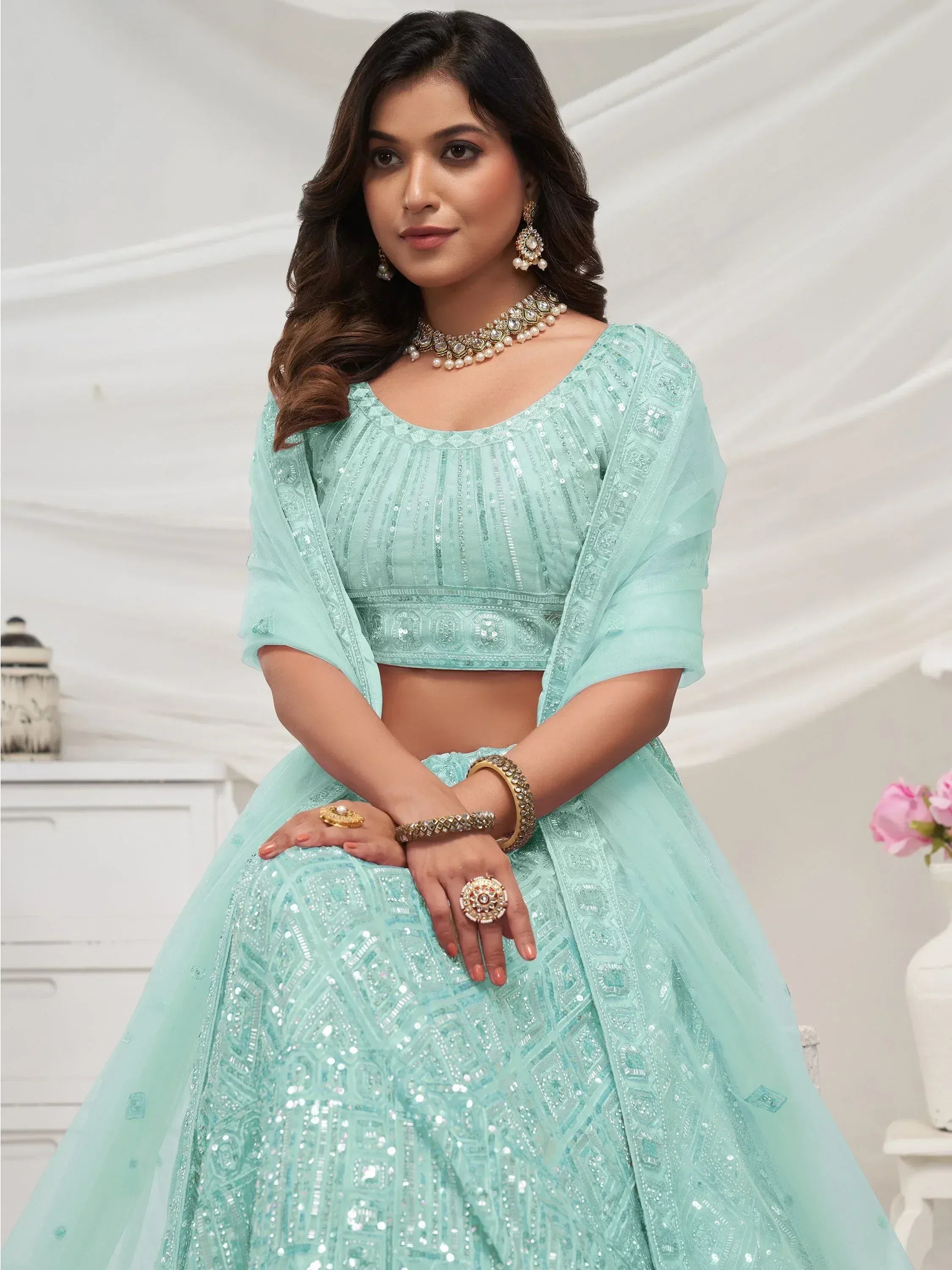 Mint green designer lehenga choli with sequin embroidery and matching jewelry
