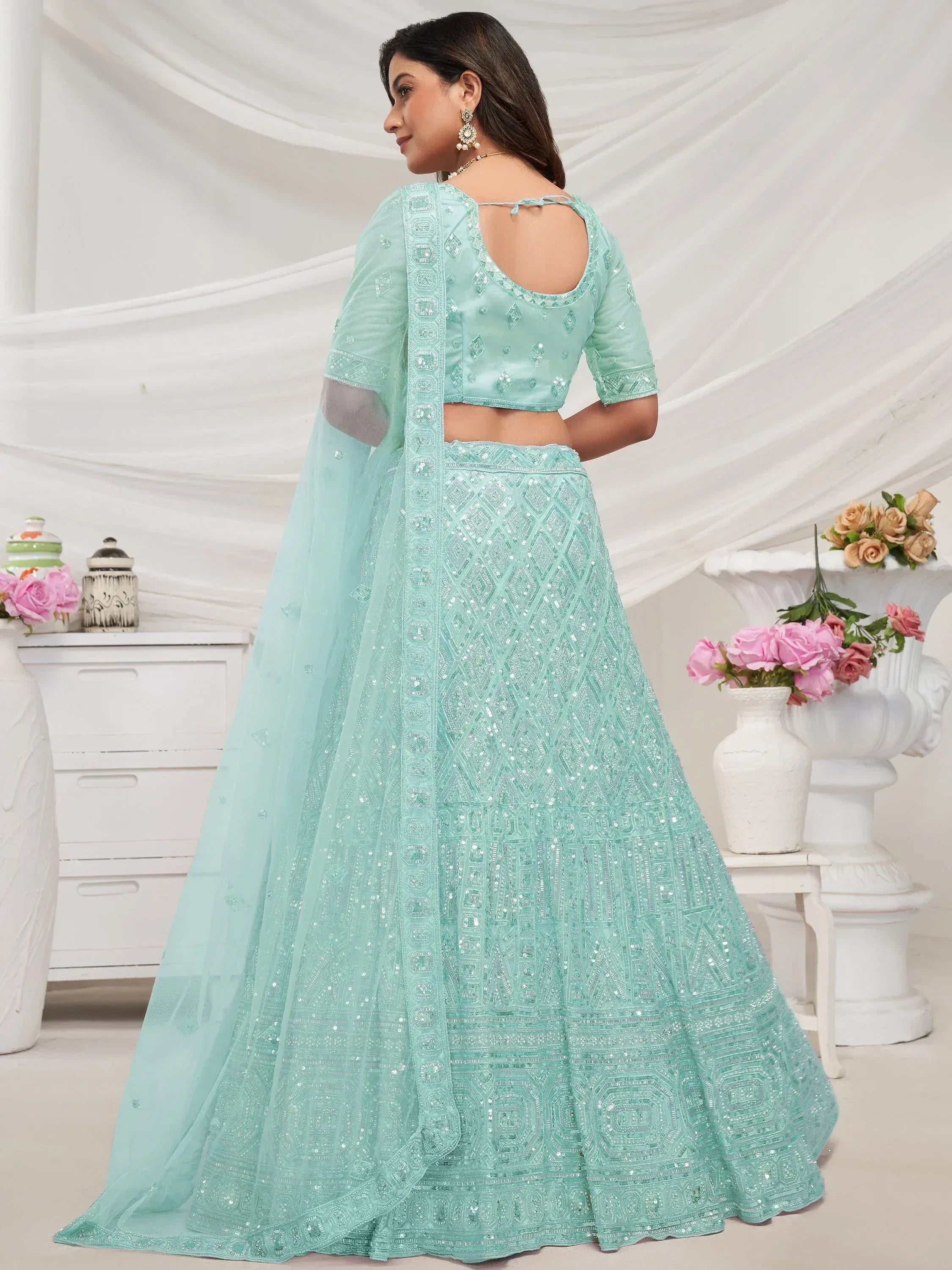 Mint green sequin lehenga choli with backless blouse and sheer dupatta, perfect for Indian ethnic wear