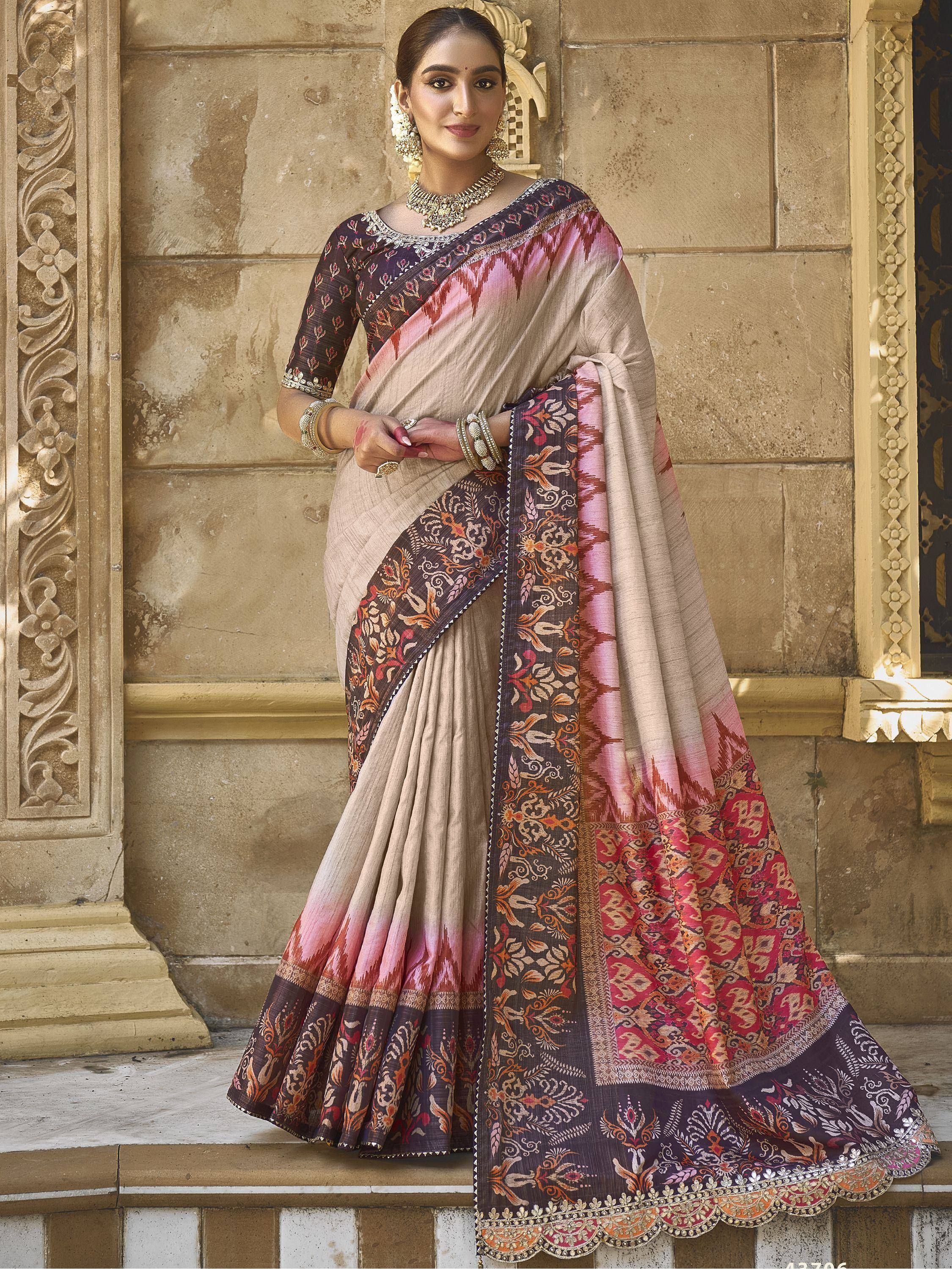 Woman in elegant beige and maroon printed saree with intricate embroidery, perfect for Indian ethnic occasions.