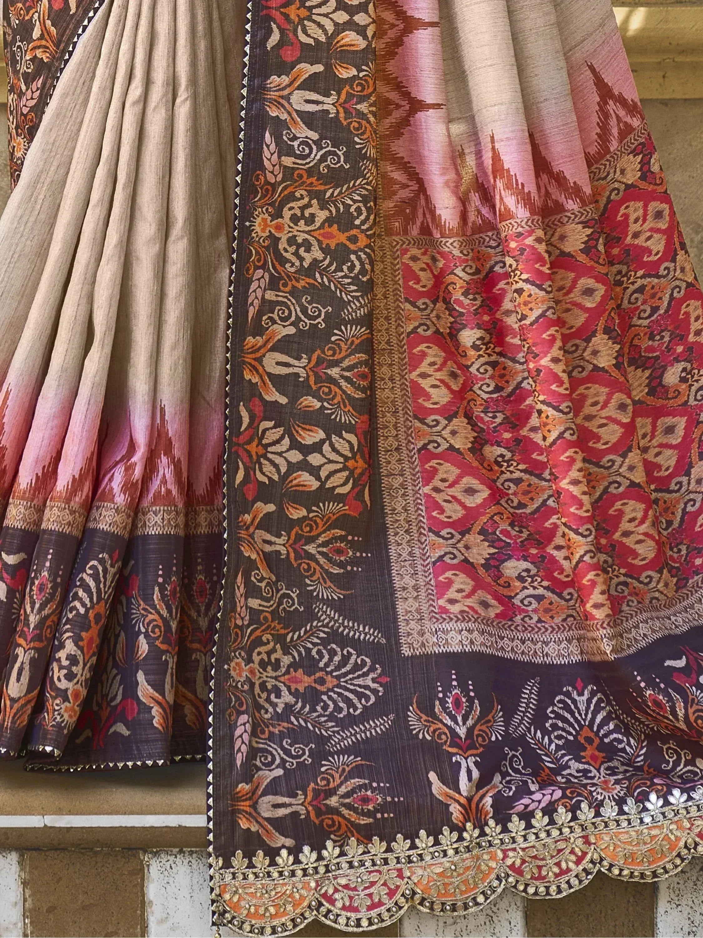 Elegant Indian ethnic saree with intricate floral and temple motifs, rich embroidery, and vibrant ombre border.