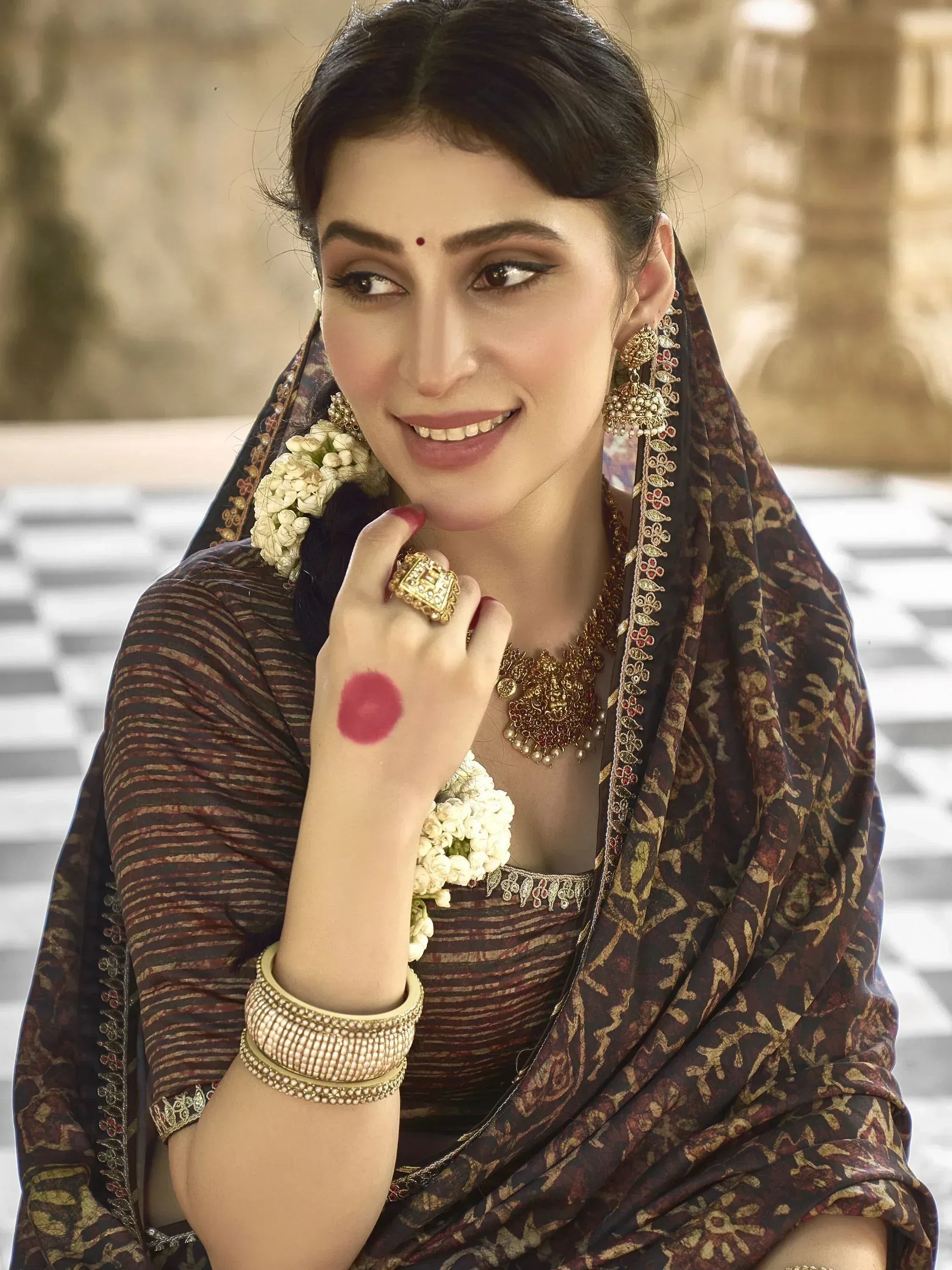 Woman in traditional Indian ethnic wear with floral hair accessories and gold jewelry