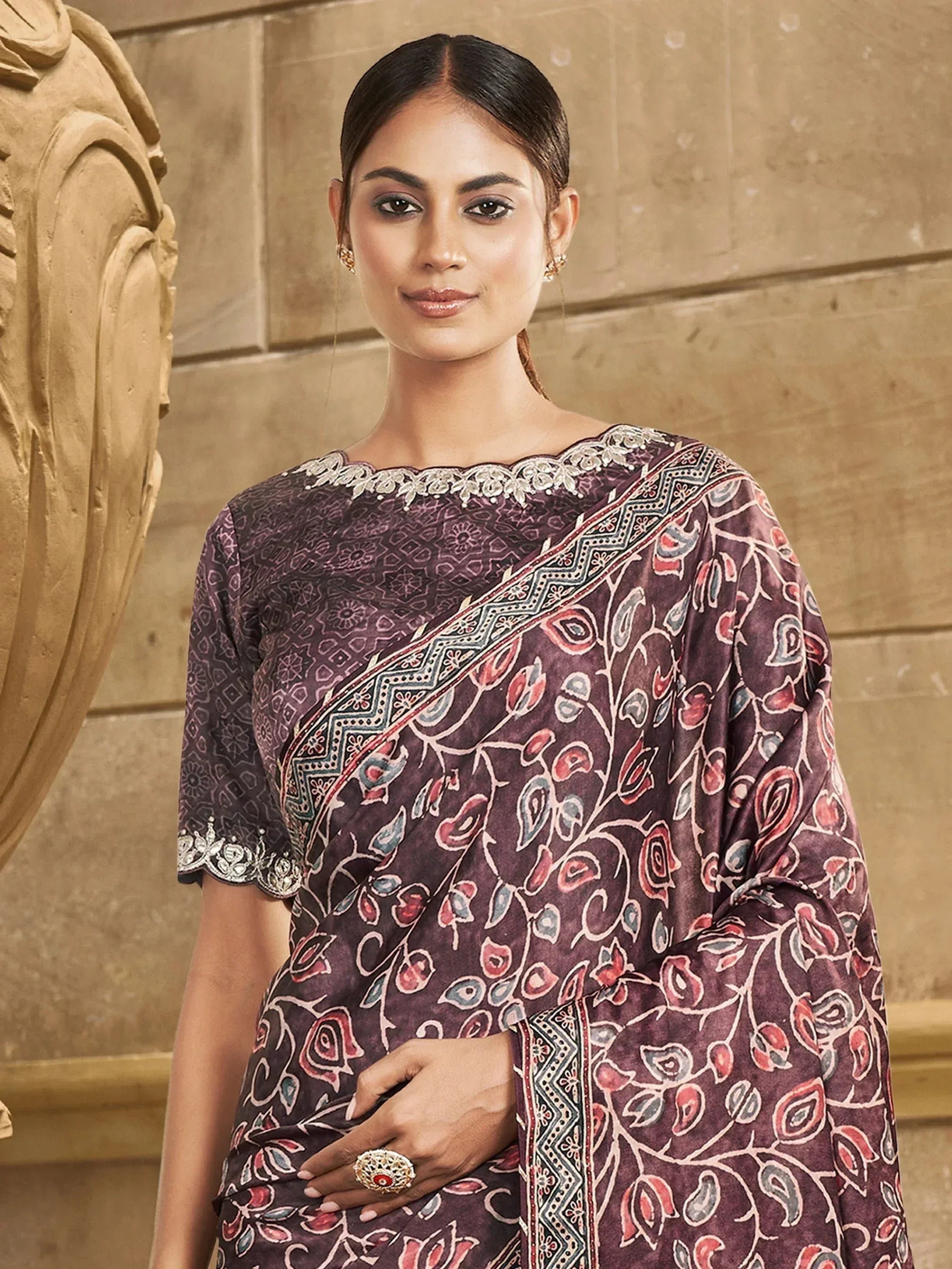 Woman in purple printed saree with floral motifs and lace neckline, ethnic Indian wear