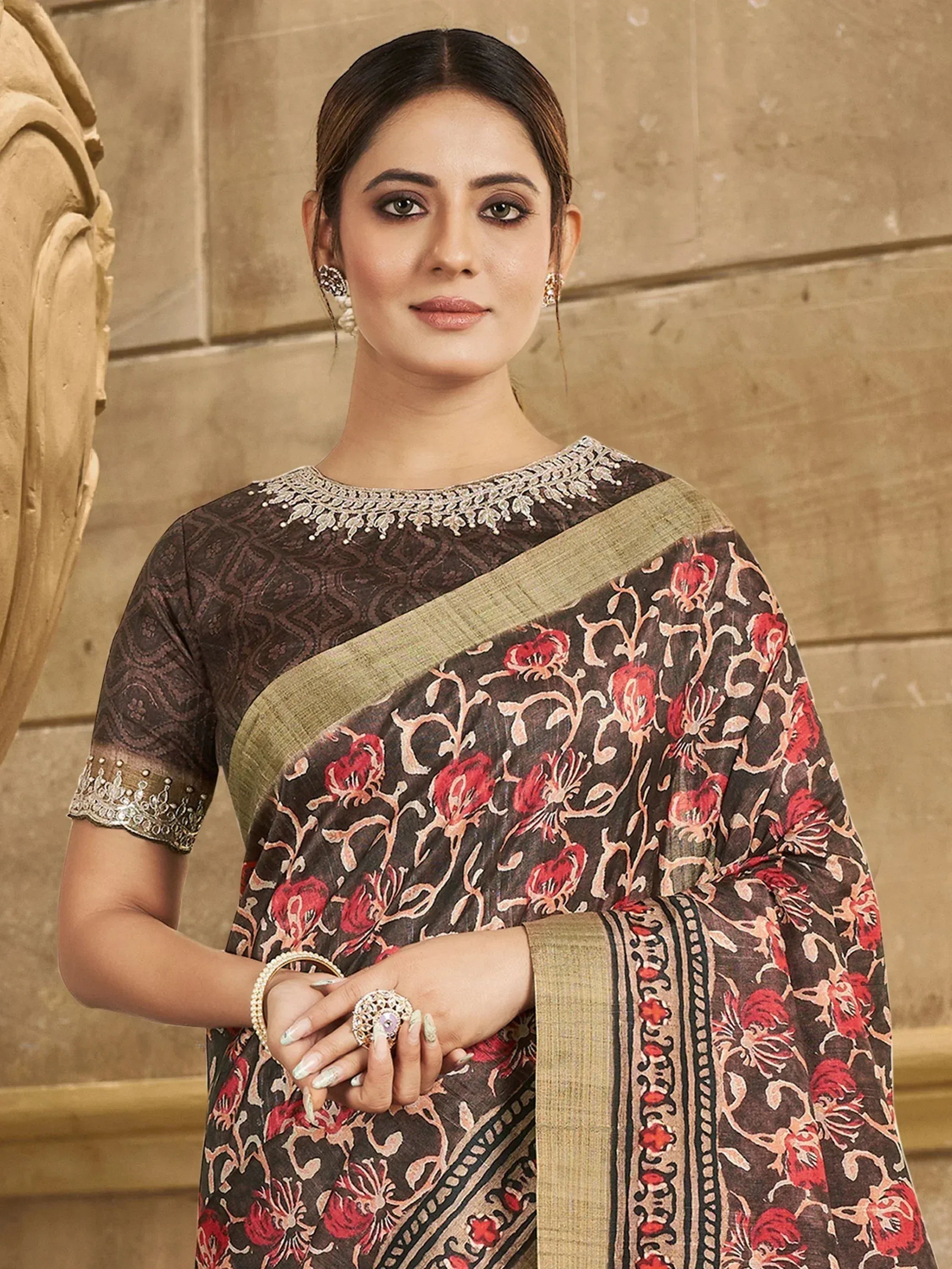 Woman in elegant brown floral saree with gold embroidery, perfect for Indian ethnic wear occasions