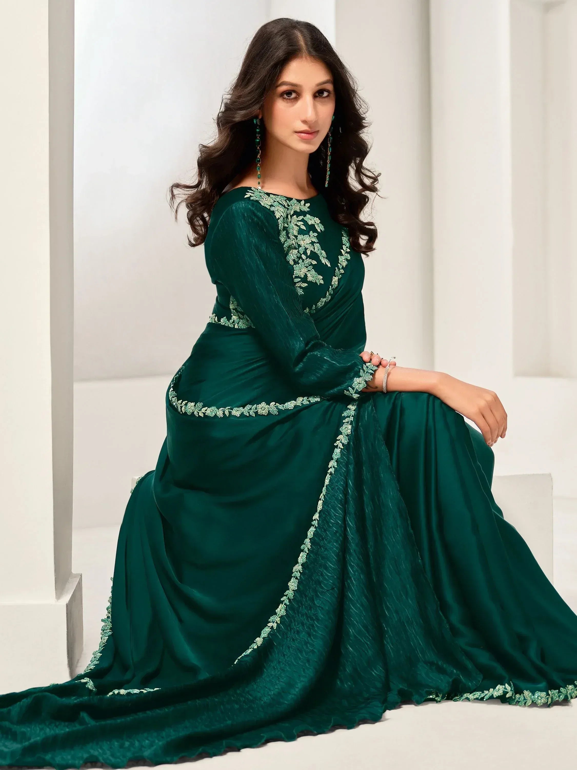 Emerald green ethnic gown with floral embroidery, perfect for Indian weddings and parties.