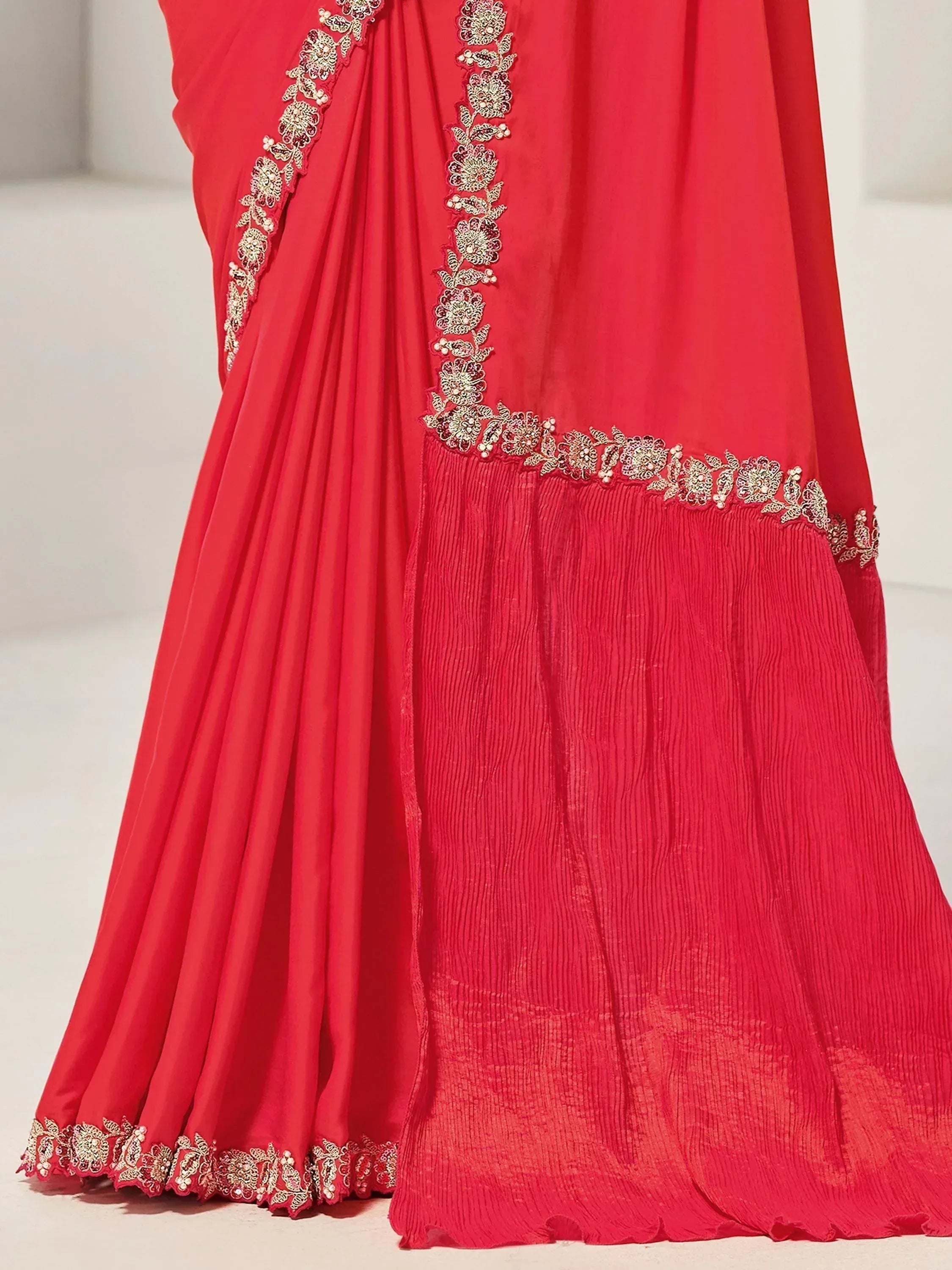 Red ethnic gown with gold floral embroidery and pleated detailing for festive occasions