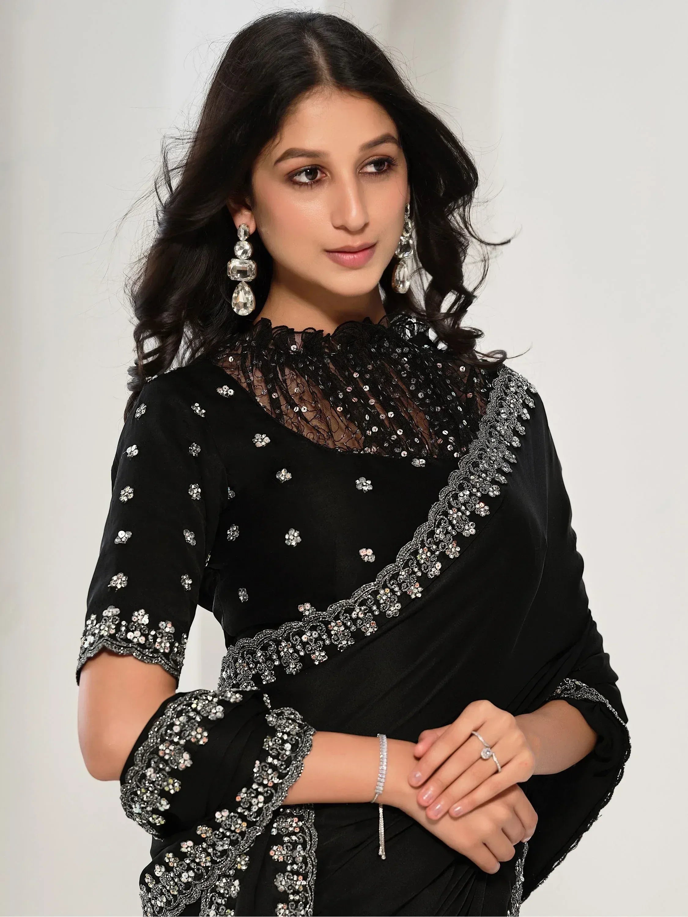 Elegant black saree with silver embroidery and sequin detailing, perfect for Indian ethnic wear occasions.