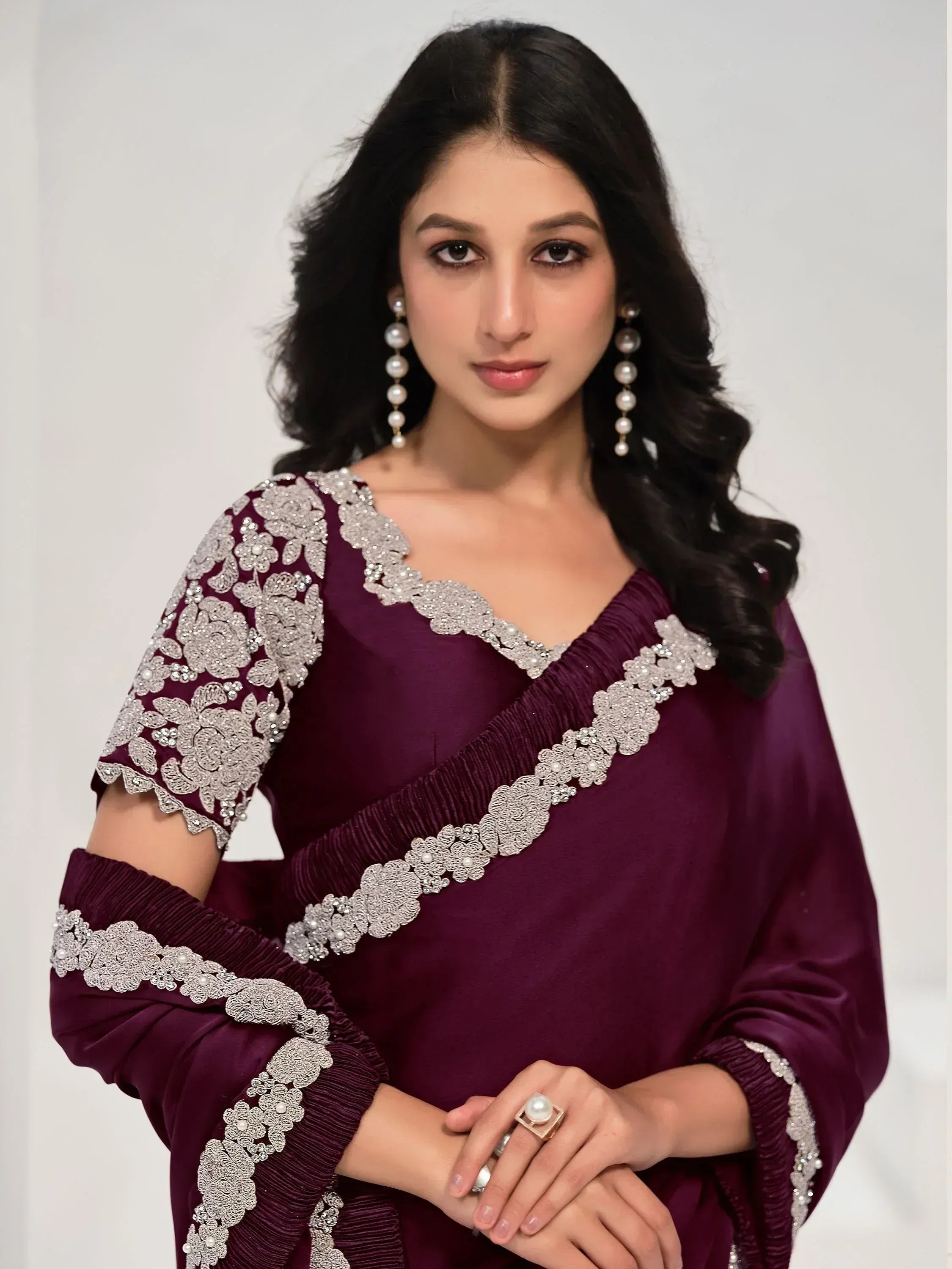 Elegant maroon ethnic gown with silver floral embroidery and pearl detailing, perfect for Indian occasions.