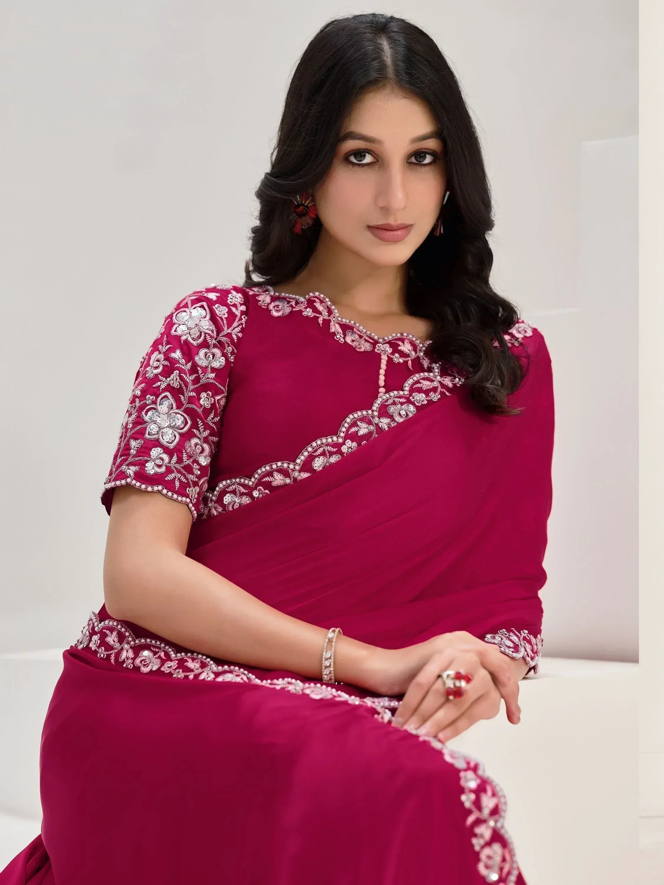 Woman in maroon embroidered saree with floral detailing, perfect for Indian ethnic occasions