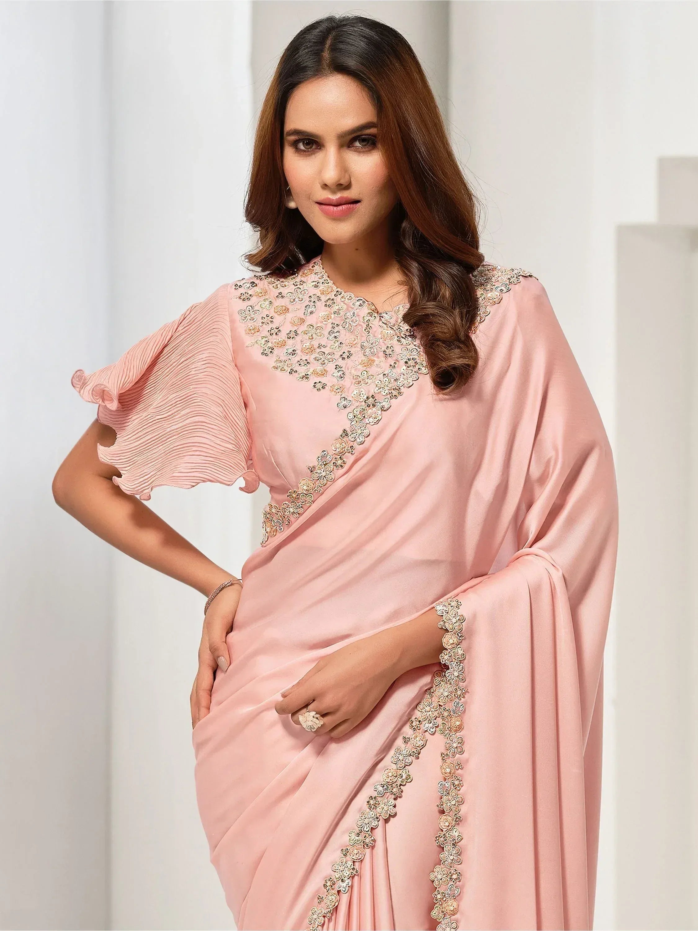 Pink designer saree with floral embroidery and ruffled sleeves, elegant Indian ethnic wear
