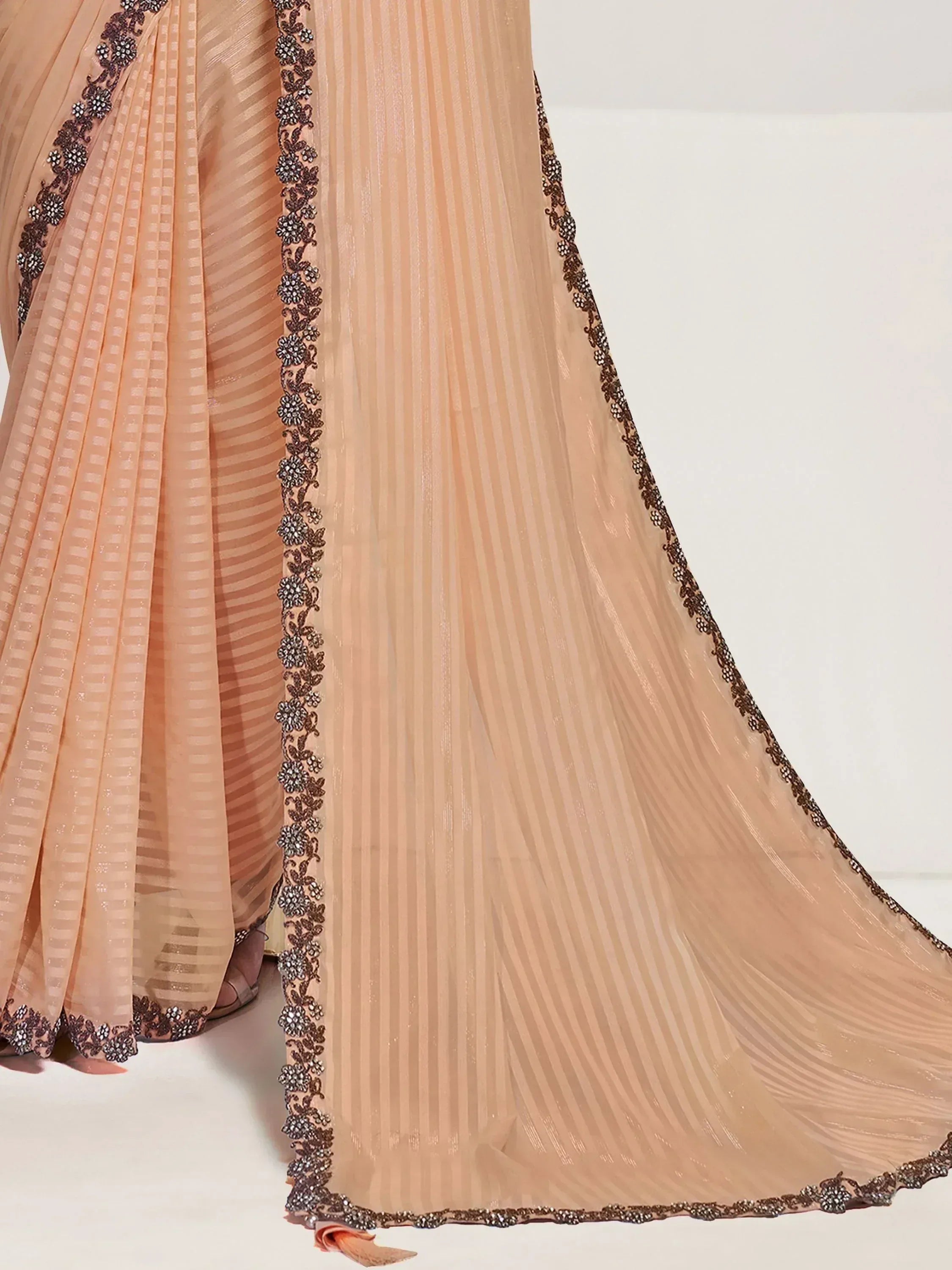 Peach ethnic gown with floral embroidery and pleated detailing for festive occasions