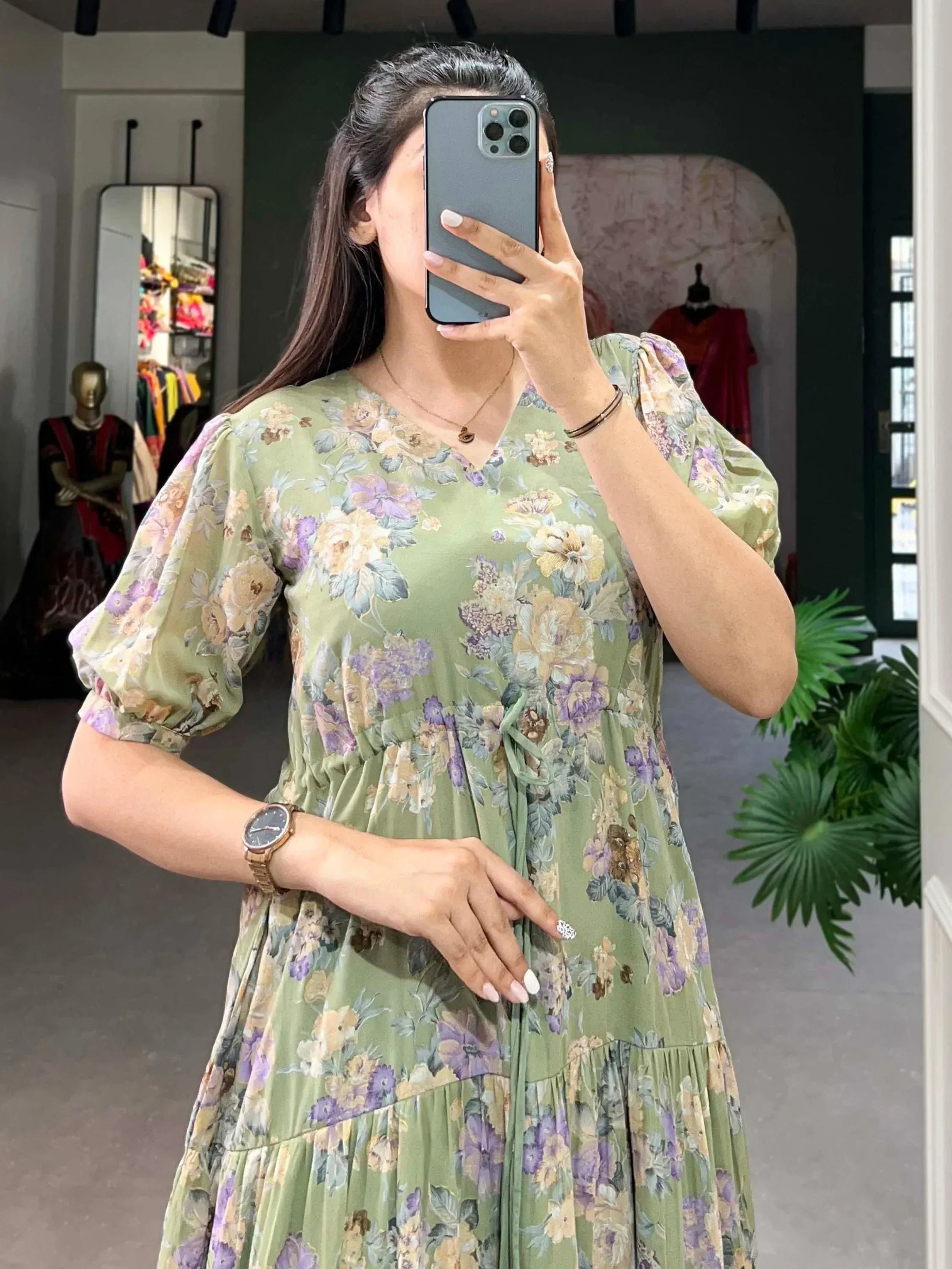Green floral print ethnic gown with puff sleeves and tiered skirt, perfect for casual or festive occasions.