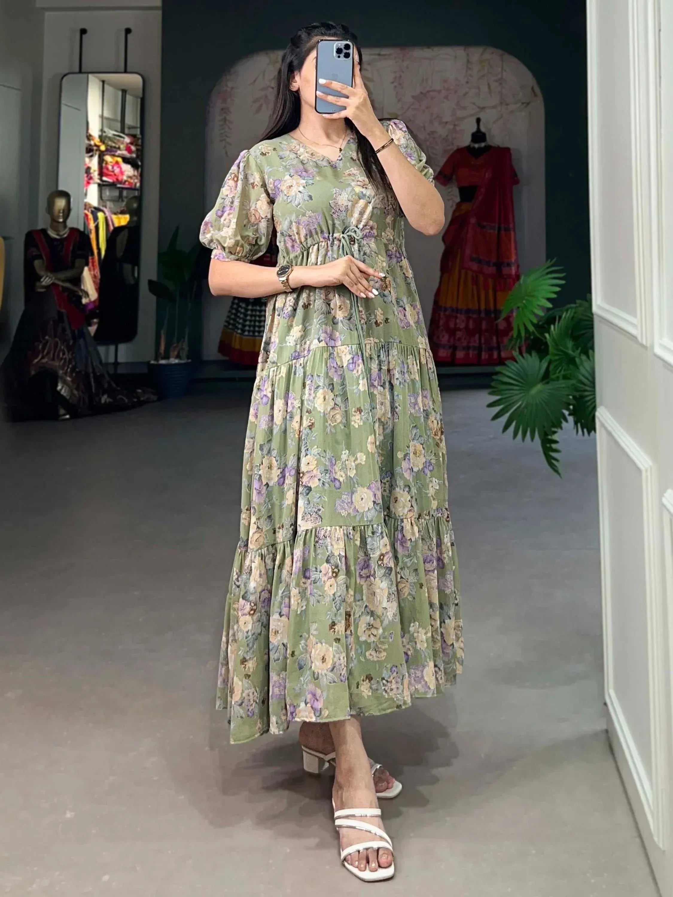 Green floral ethnic gown with puff sleeves, tiered skirt, perfect for Indian occasions and parties.