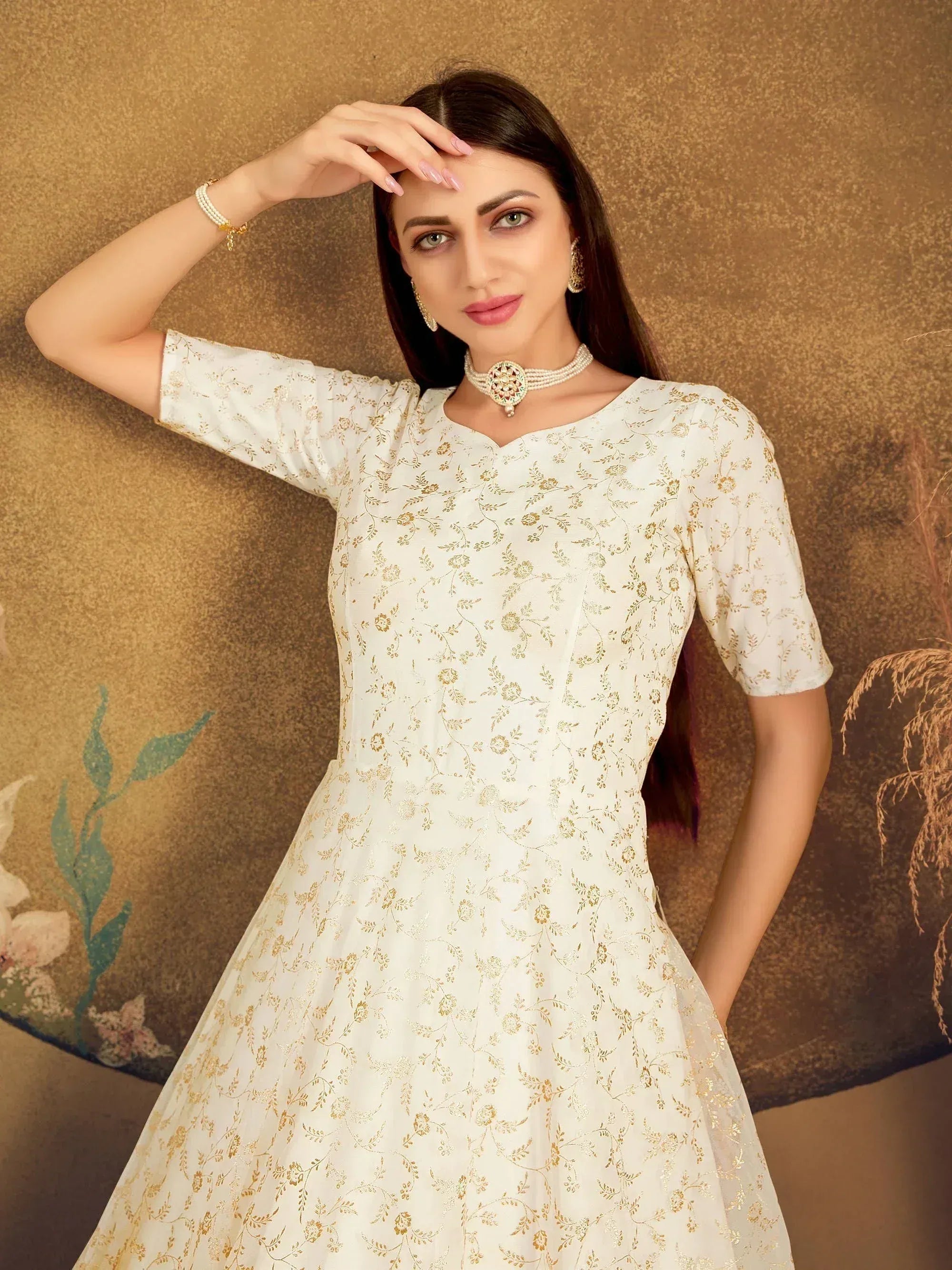 White ethnic gown with gold floral print, perfect for Indian occasions and festive wear.