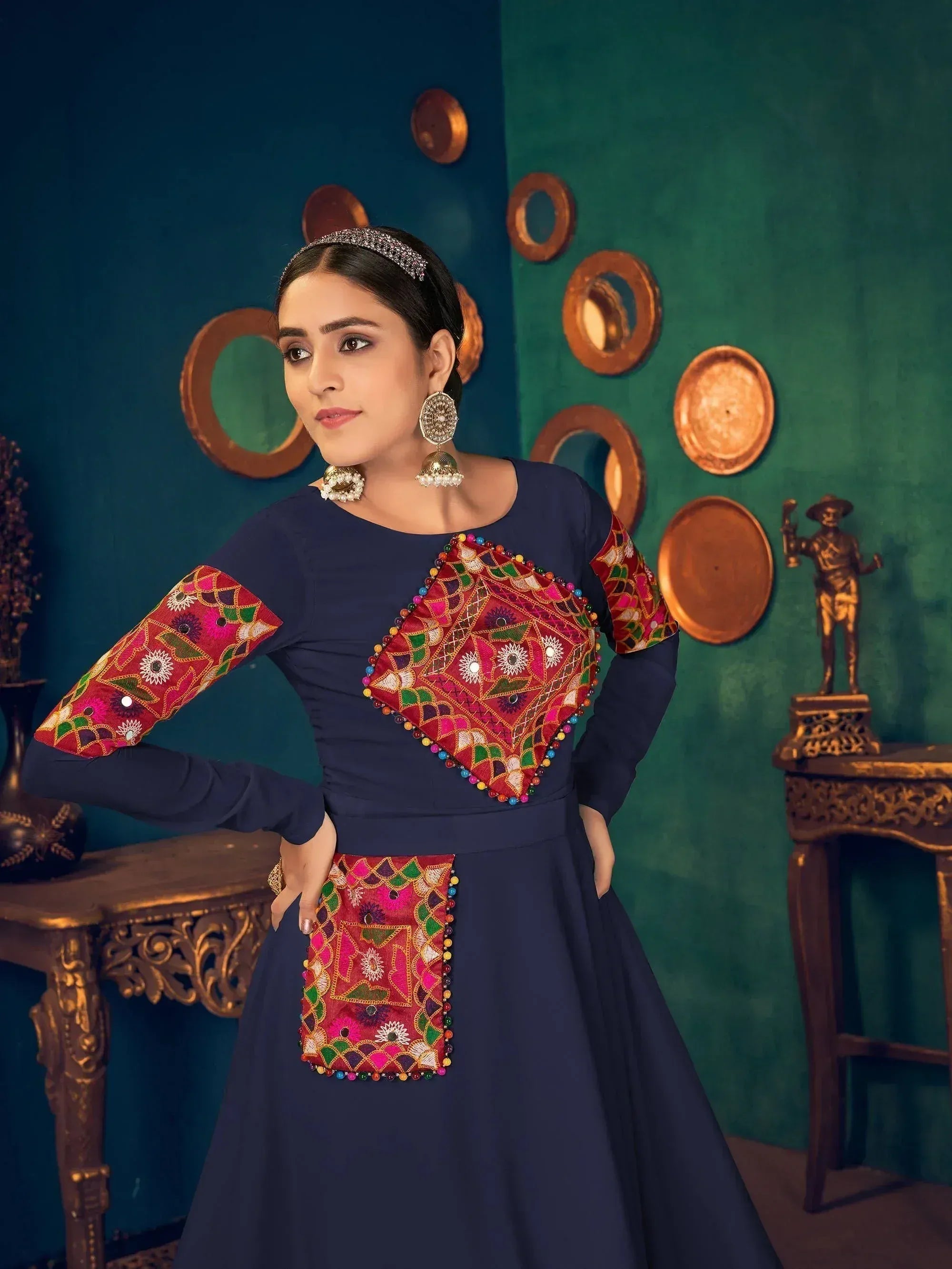 Navy blue ethnic gown with vibrant mirror work and colorful embroidery, perfect for Indian festive occasions.