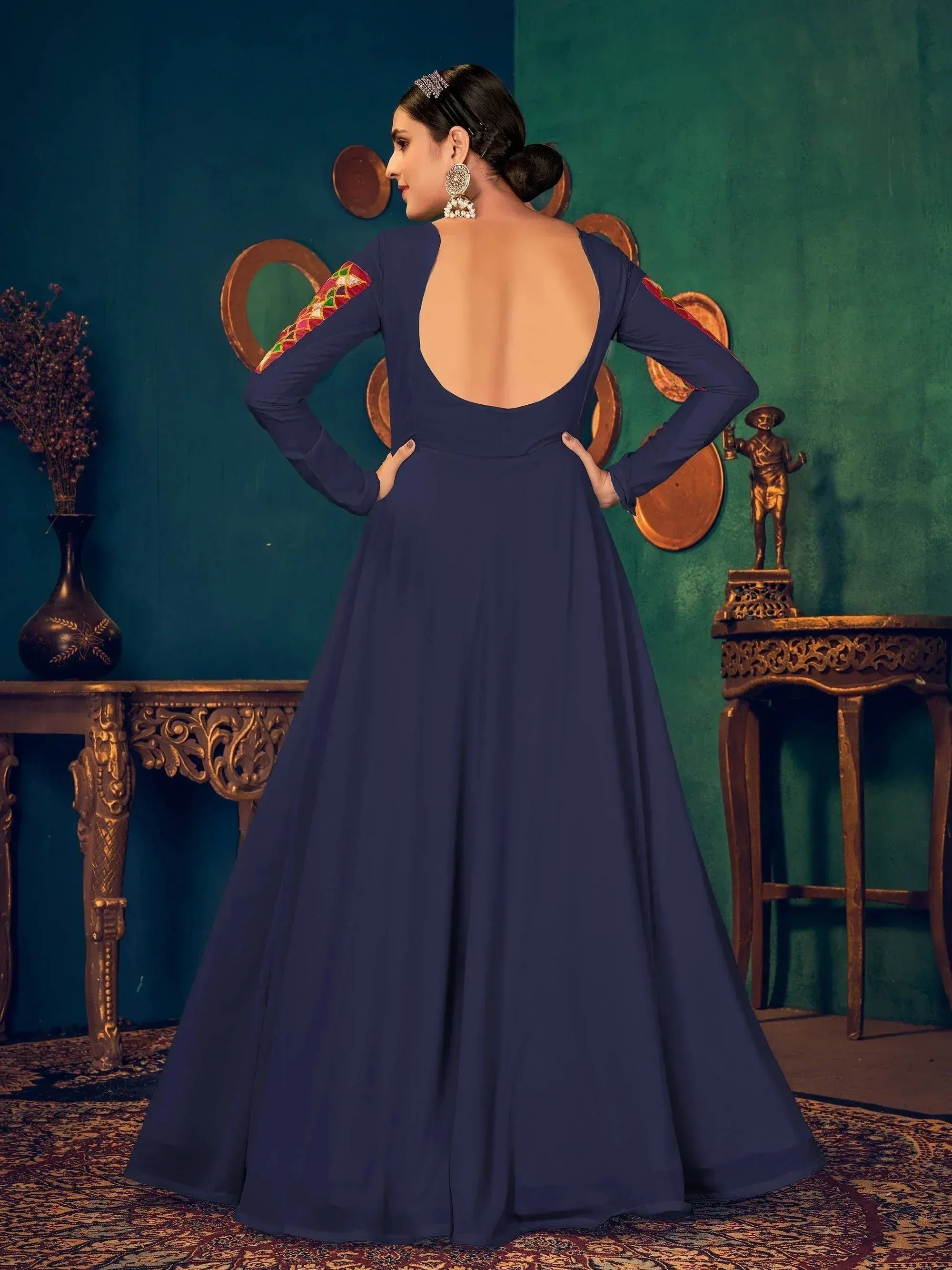 Navy blue ethnic gown with backless design and embroidered sleeves, perfect for Indian festive occasions