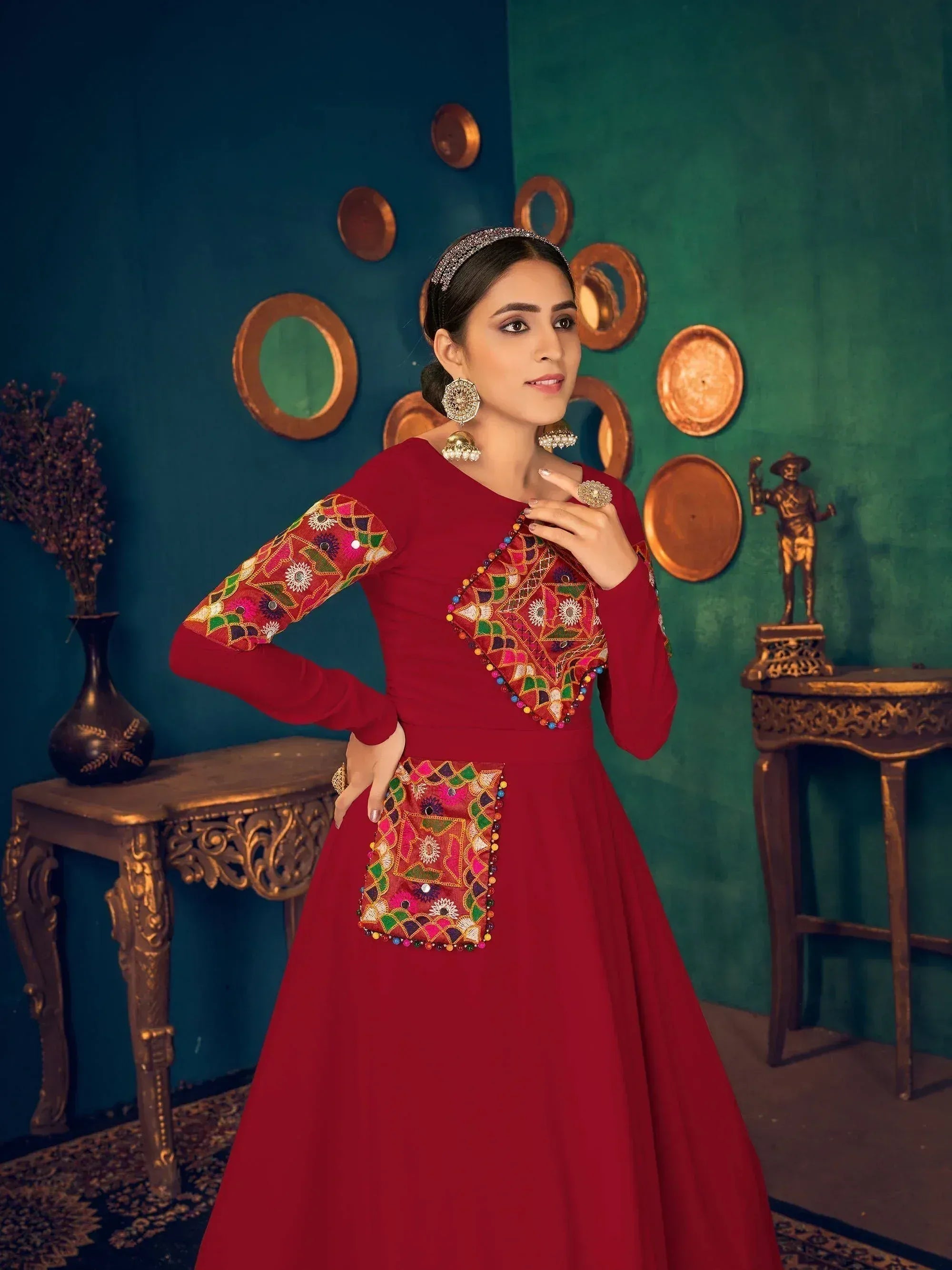 Red ethnic gown with colorful mirror work and embroidery, perfect for Indian festive occasions