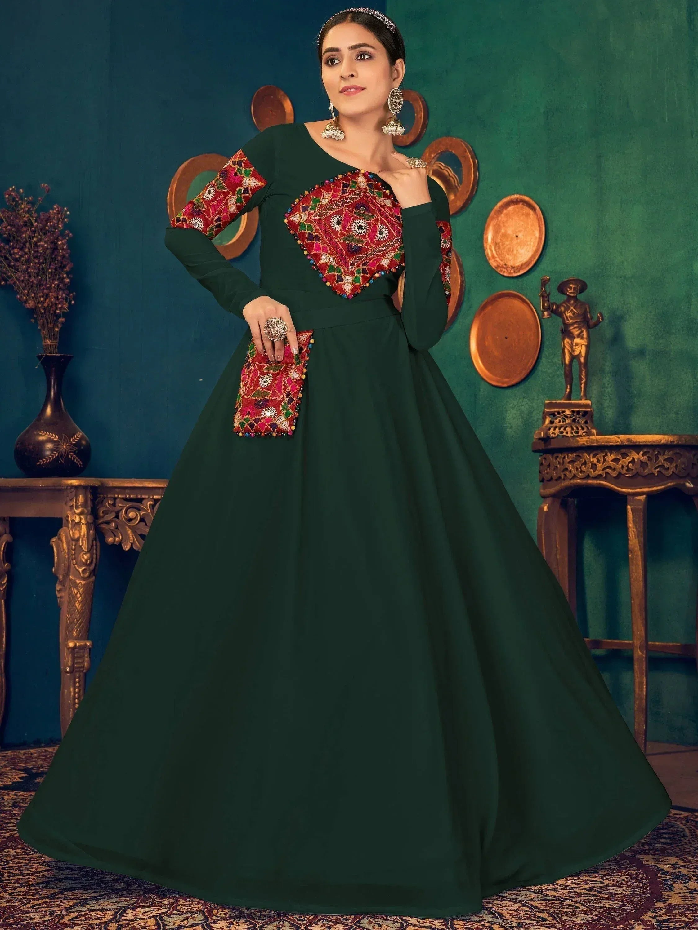 Emerald green ethnic gown with colorful mirror work, perfect for Indian weddings and festive occasions.