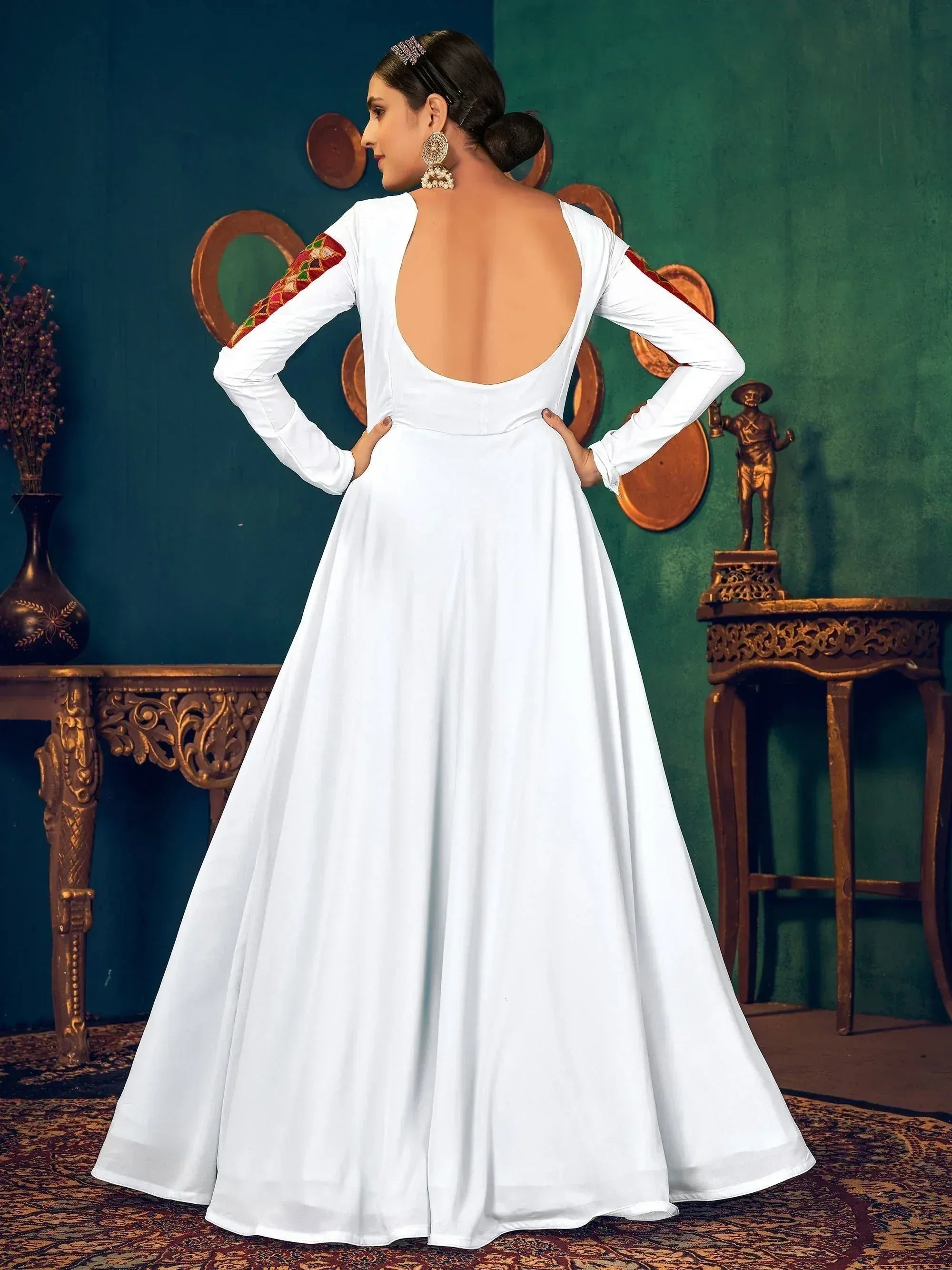 White ethnic gown with open back and embroidered sleeves, perfect for Indian occasions
