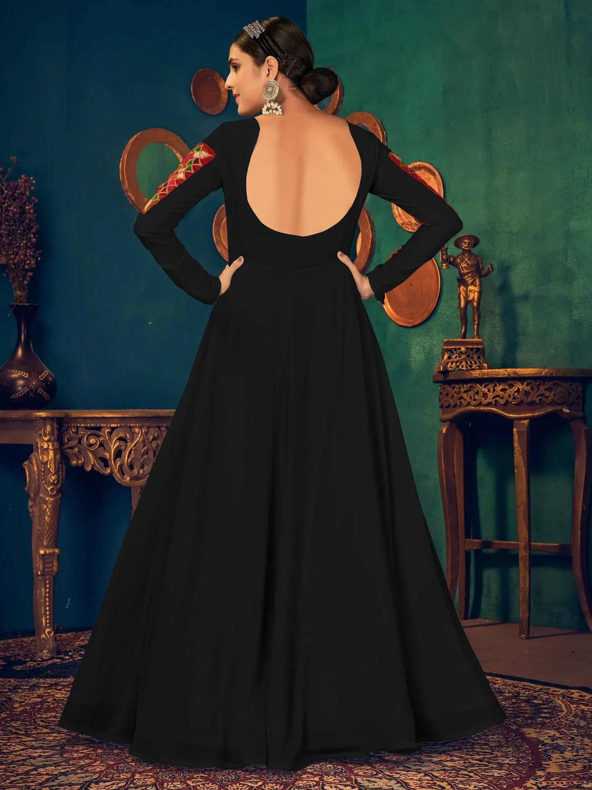 Black ethnic gown with backless design and embroidered sleeves, perfect for Indian occasions.