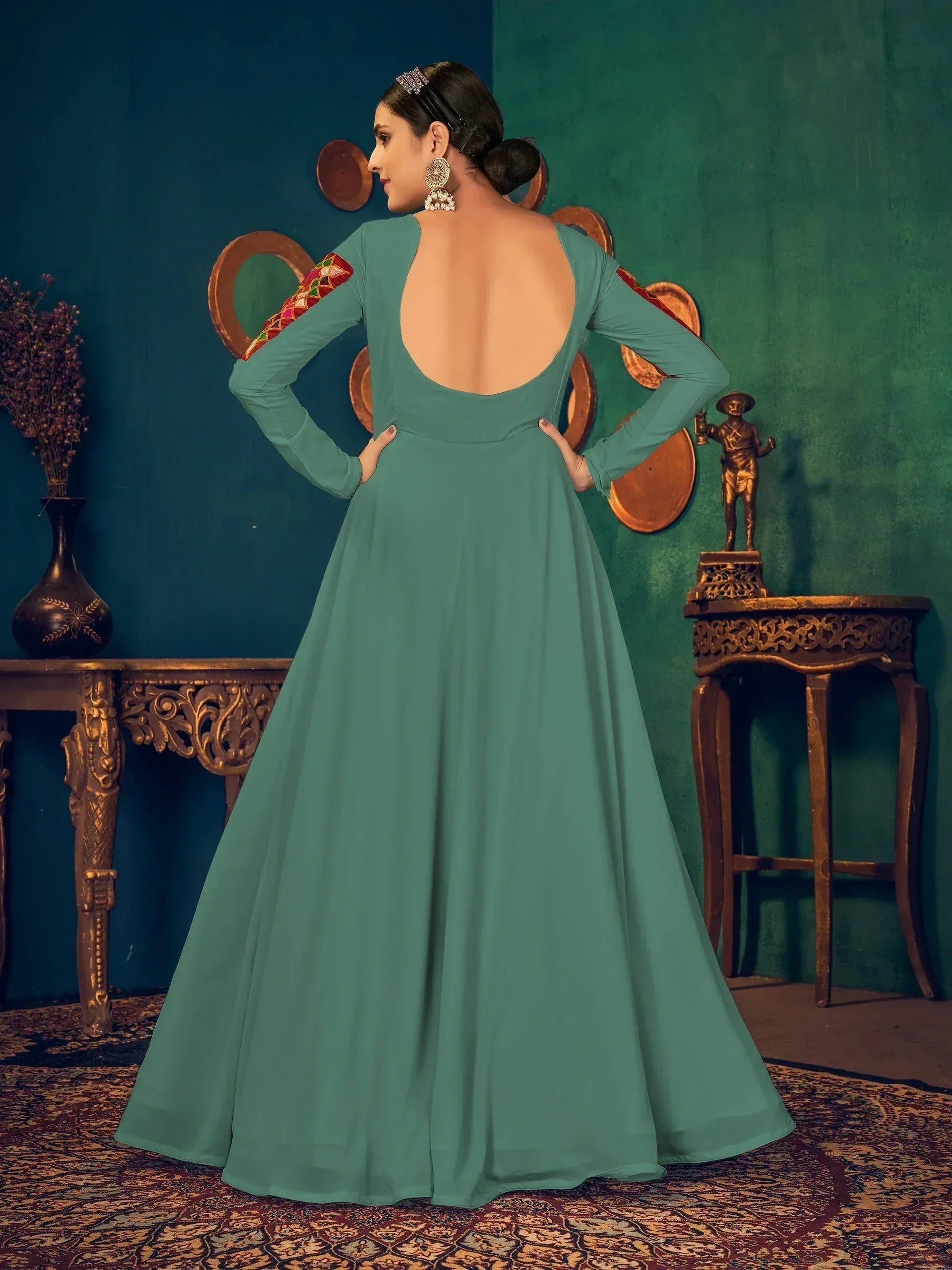 Teal ethnic gown with open back and embroidered sleeves, perfect for Indian festive occasions