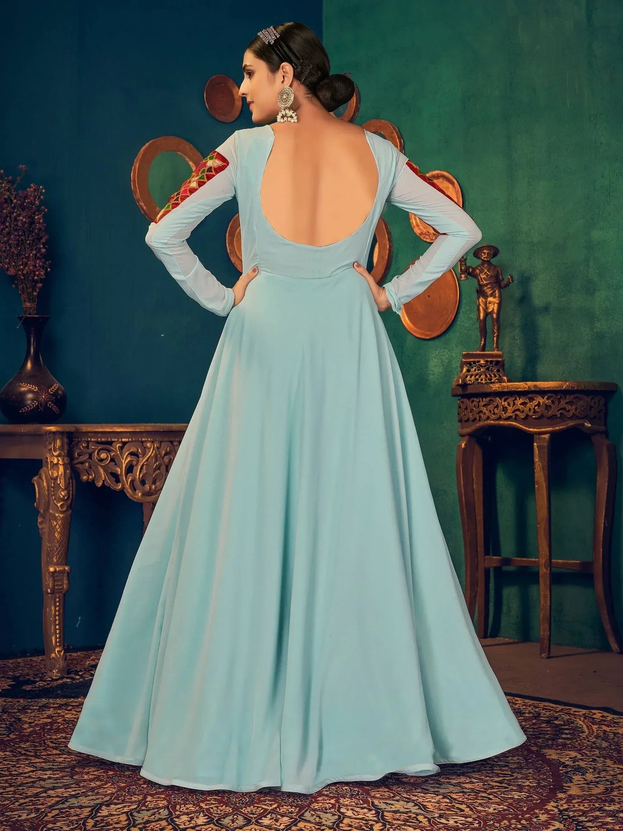 Light blue ethnic gown with open back and embroidered sleeves, perfect for Indian occasions.