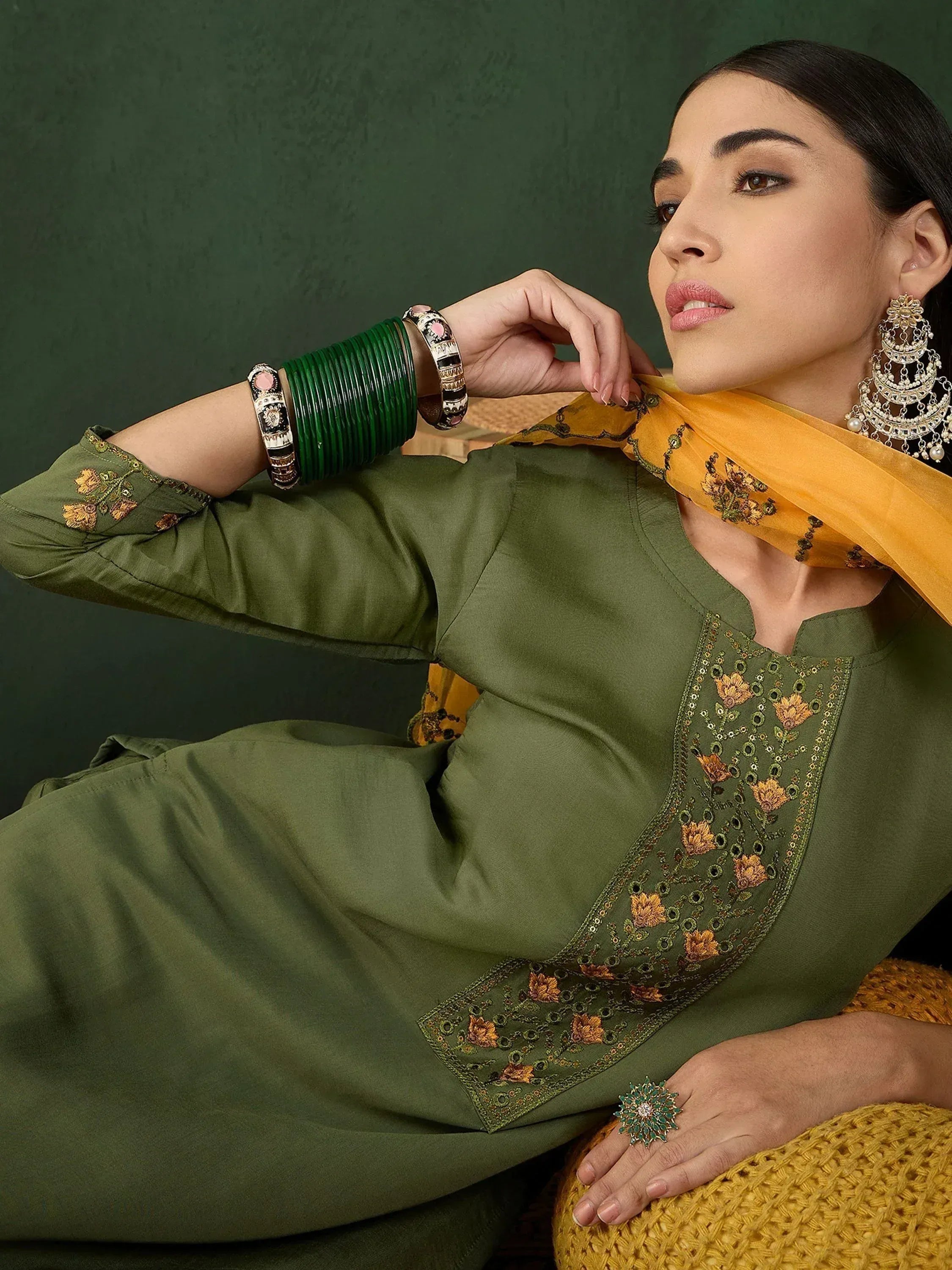 Olive green embroidered kurta with yellow dupatta, traditional Indian ethnic wear, paired with bangles and jhumka earrings.