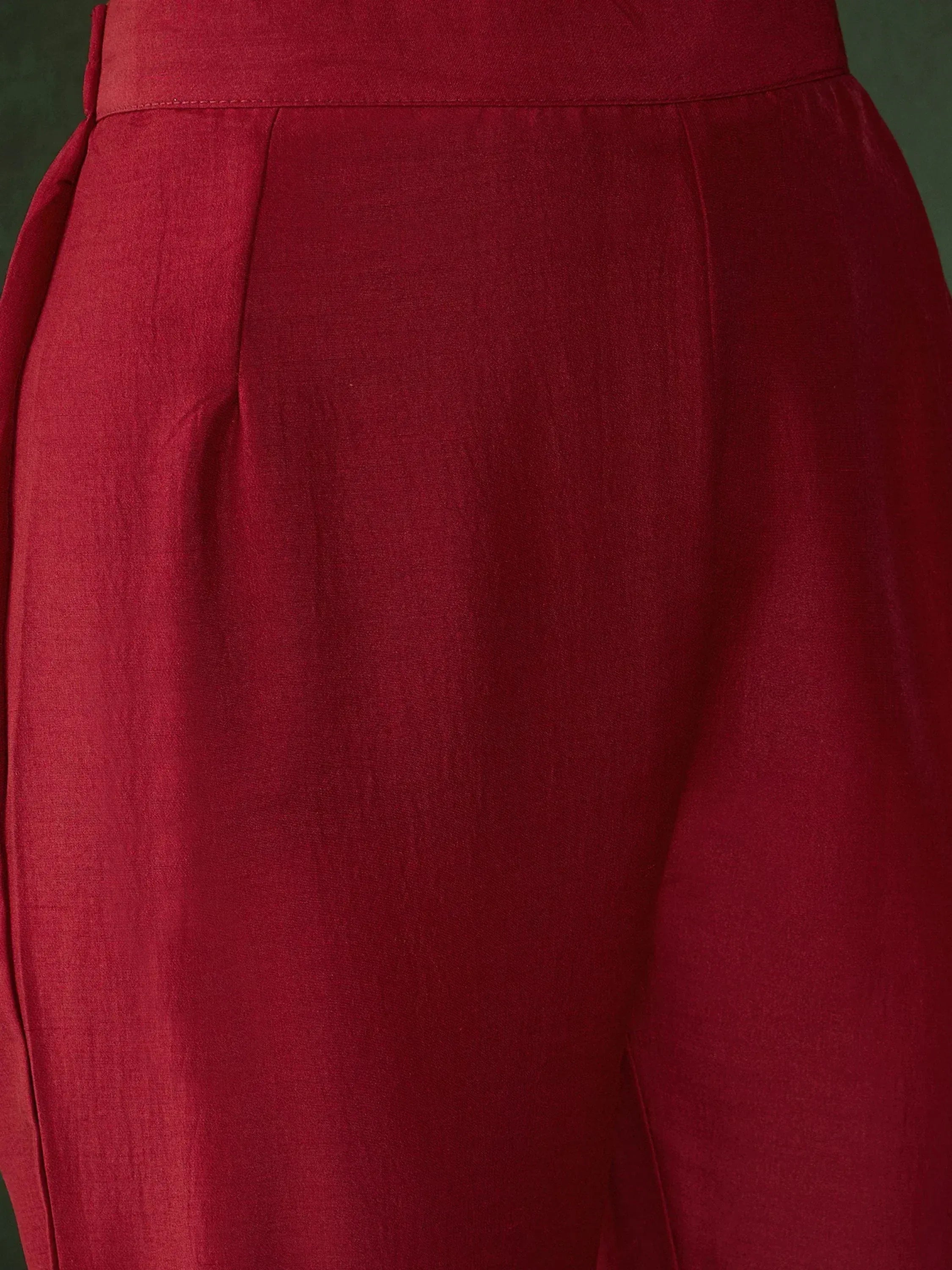 Rich maroon ethnic gown with pleated waist detail, perfect for Indian festive occasions