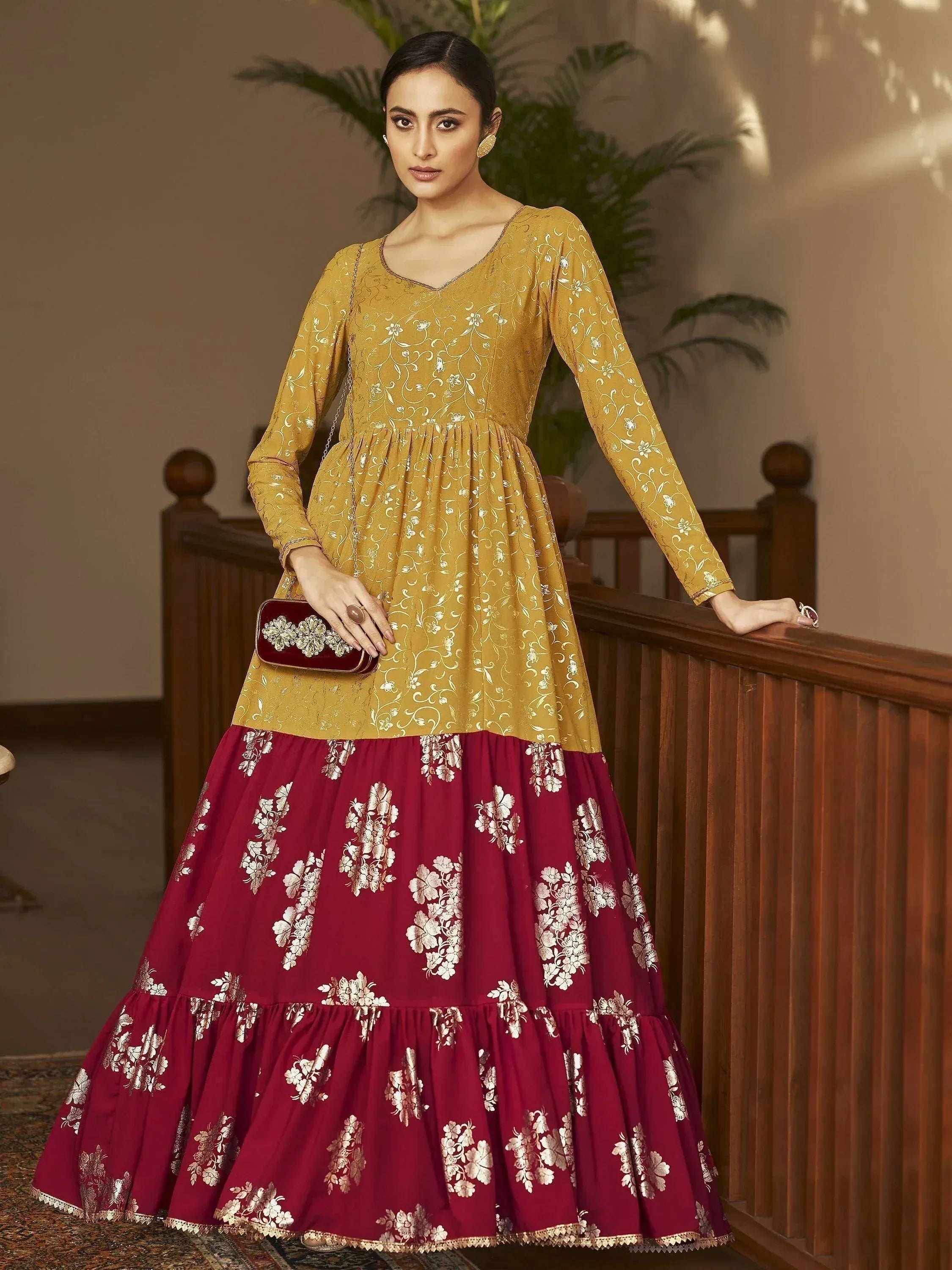 Woman in mustard yellow and maroon floral printed ethnic gown with long sleeves