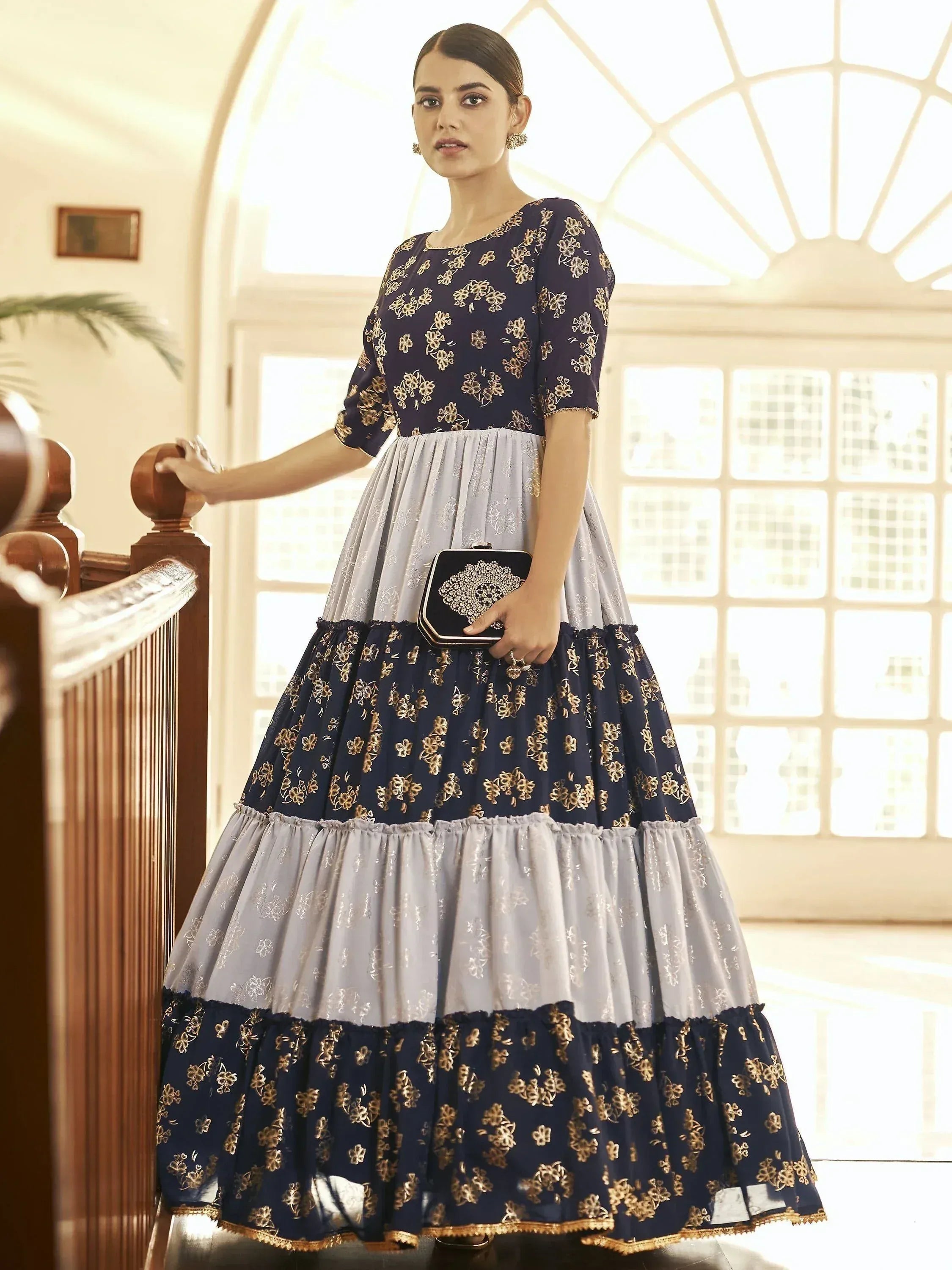 Navy blue and grey tiered ethnic gown with gold floral embroidery, perfect for festive occasions