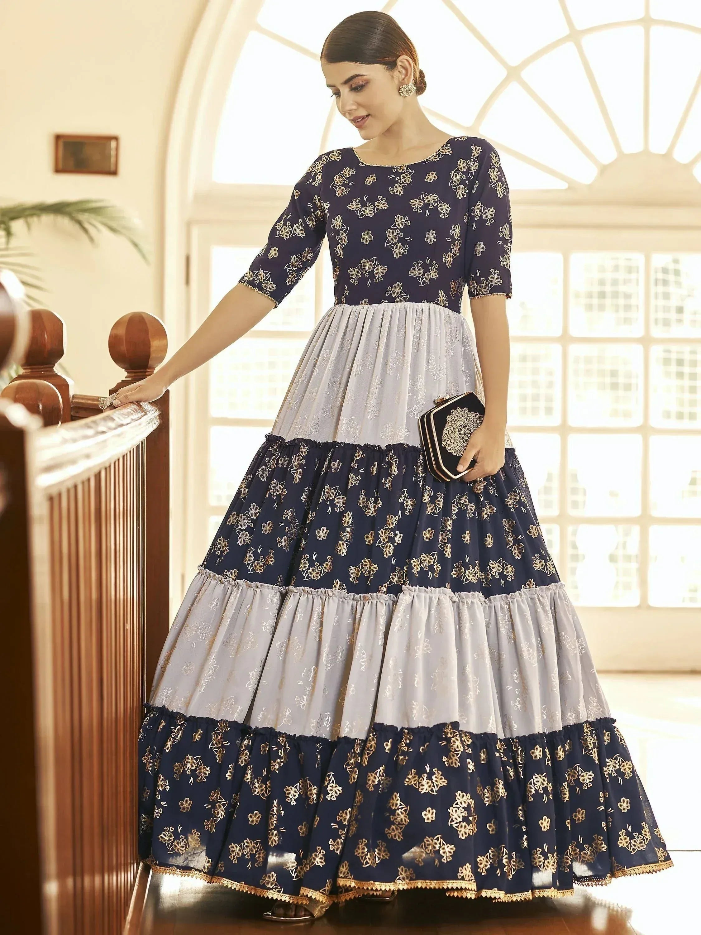 Navy and silver floral embroidered tiered ethnic gown with gold detailing, perfect for Indian occasions.