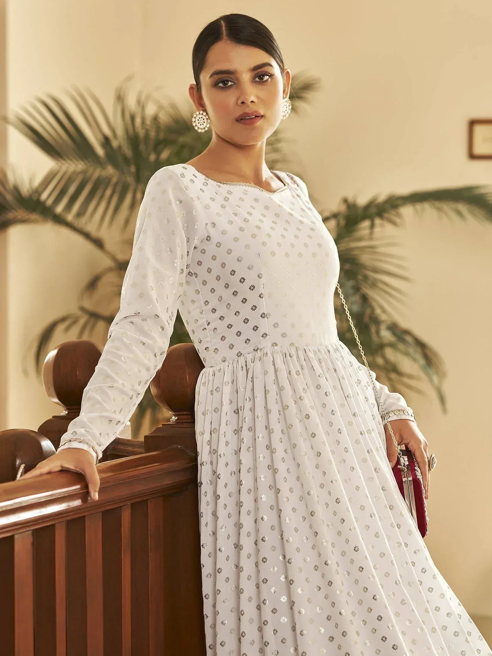 White ethnic gown with silver floral print, long sleeves, and pleated skirt for Indian occasions