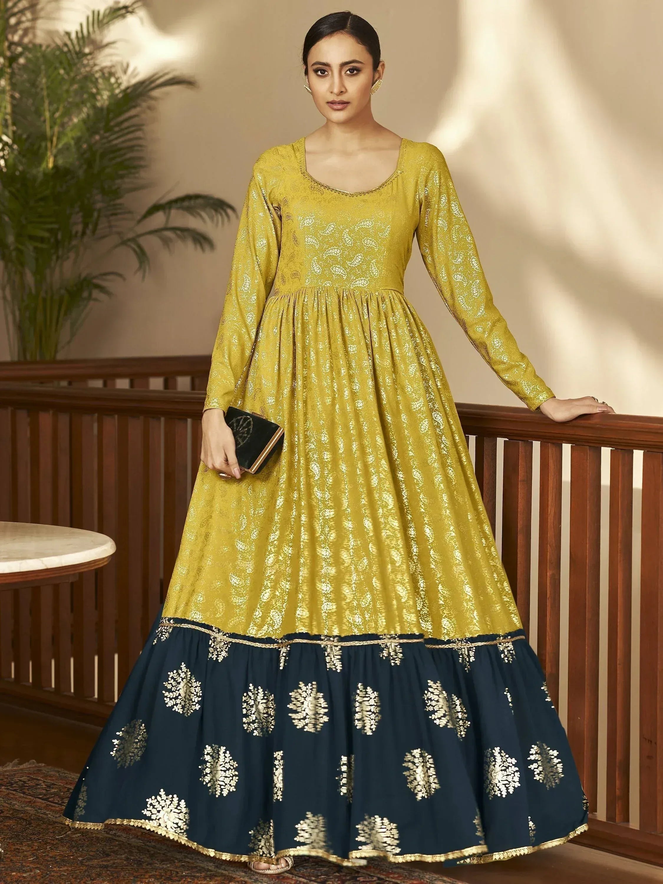 Elegant yellow and navy blue ethnic gown with gold embroidery, perfect for festive occasions.