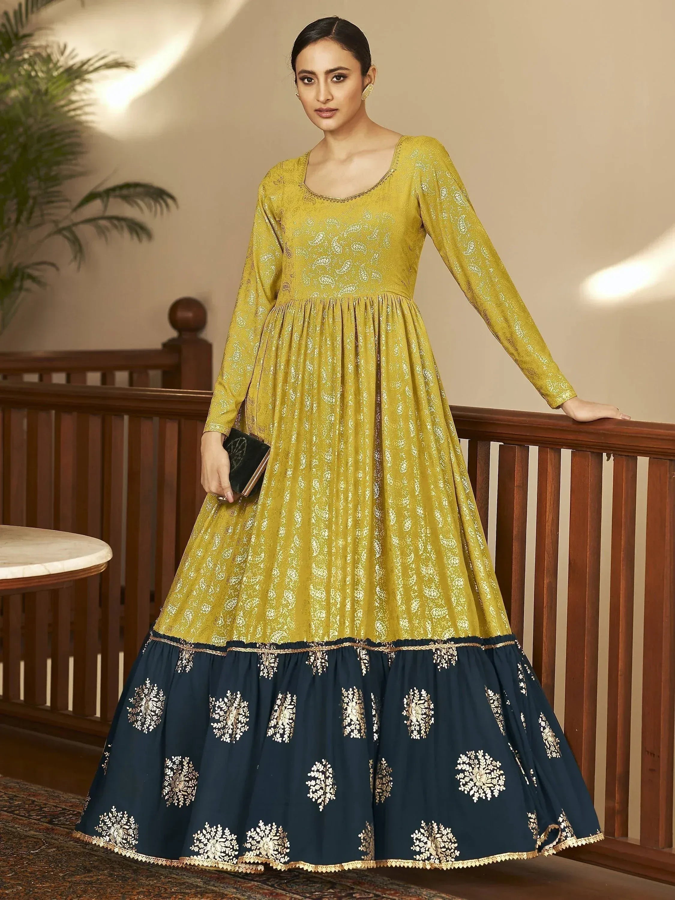 Elegant mustard and navy ethnic gown with floral embroidery, perfect for Indian festive occasions.