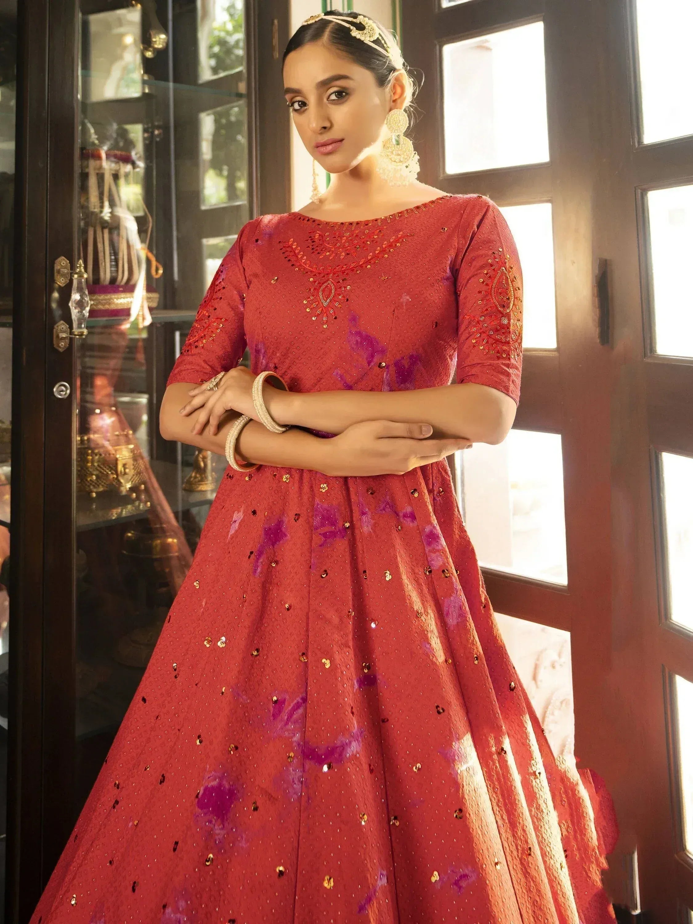 Red embroidered ethnic gown with purple accents, perfect for Indian weddings or festive occasions.