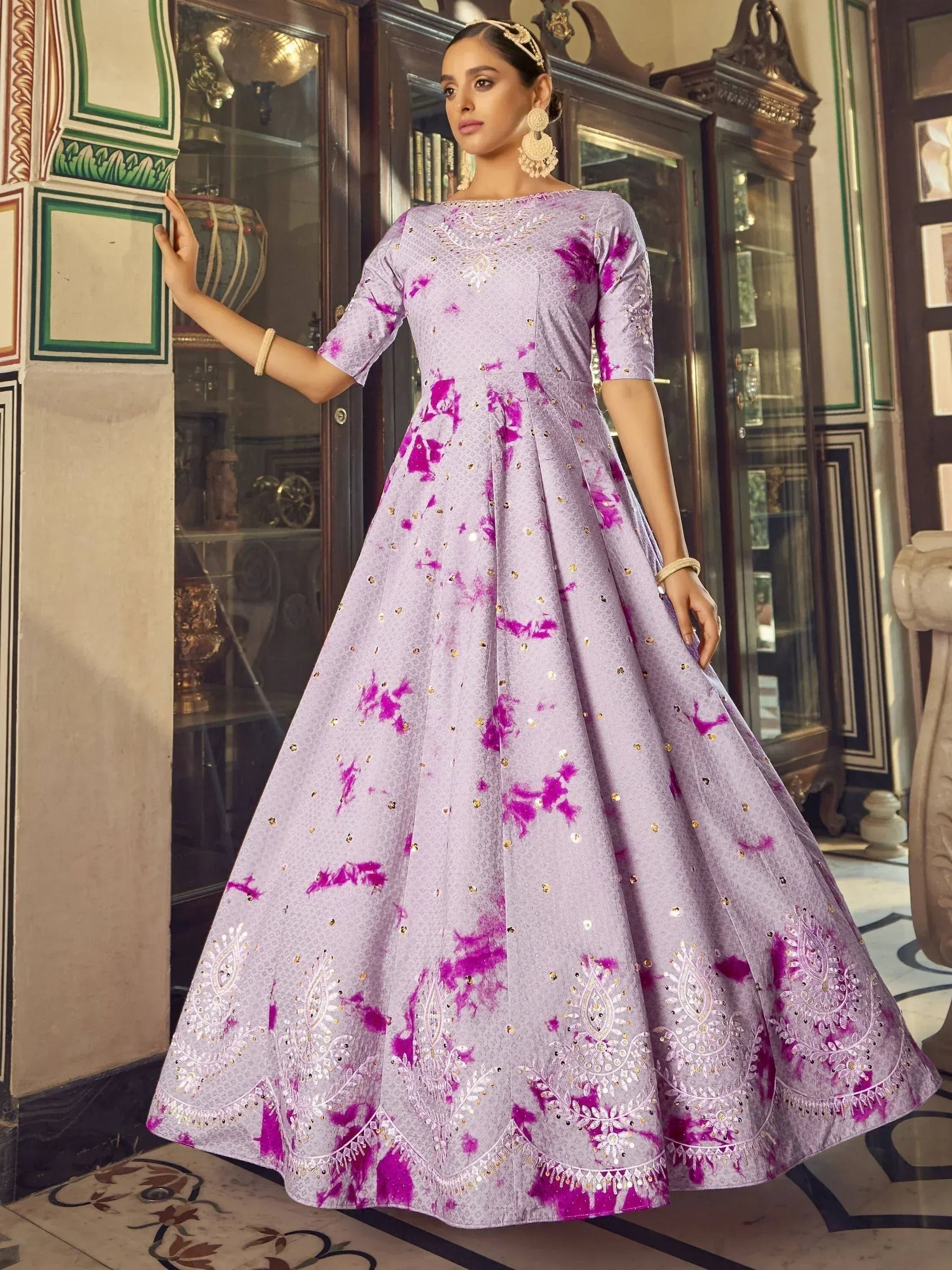 Lavender ethnic gown with pink tie-dye print and gold embroidery, perfect for Indian occasions
