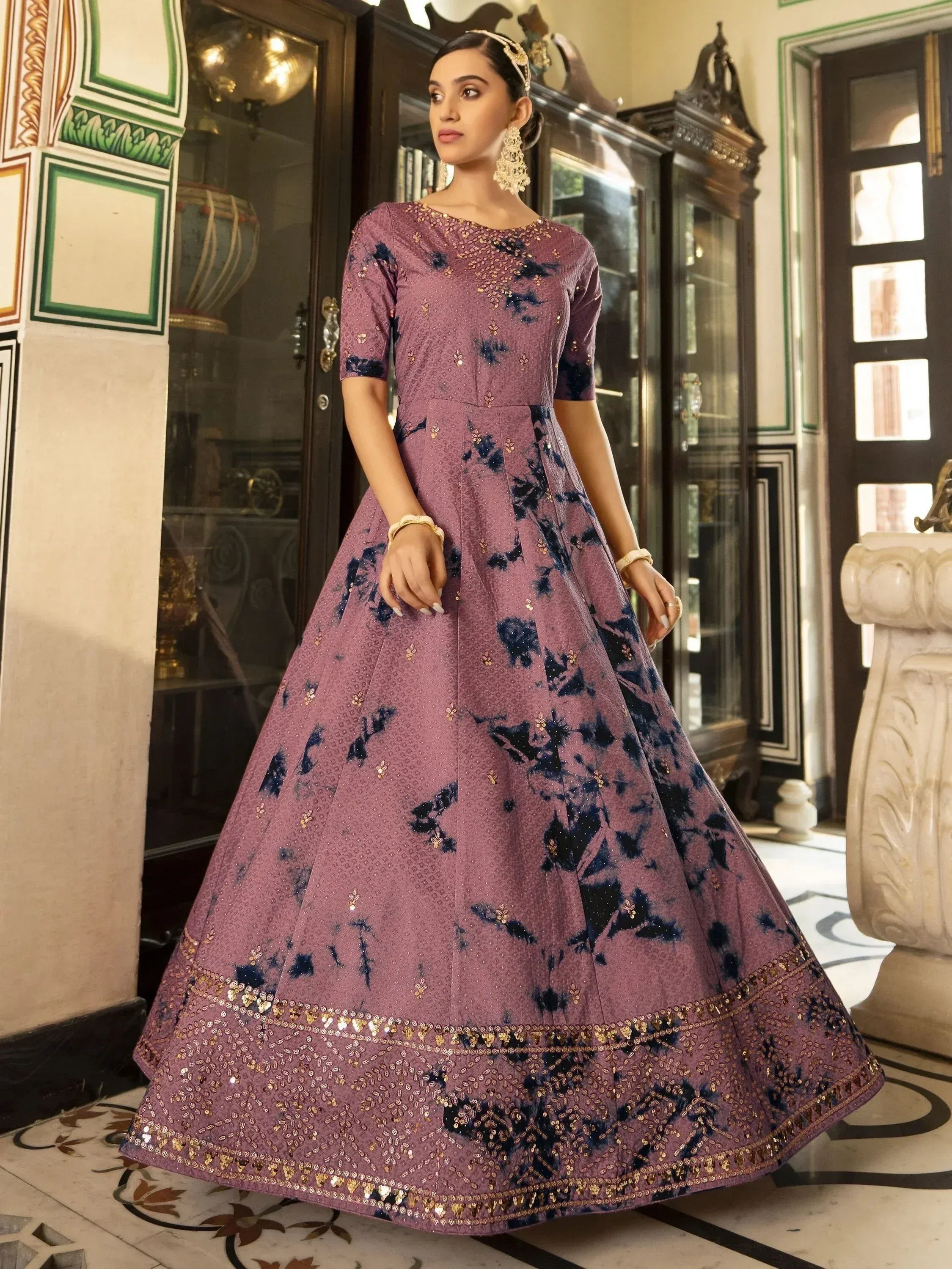 Elegant purple ethnic gown with navy floral print and gold sequin detailing, perfect for Indian occasions.