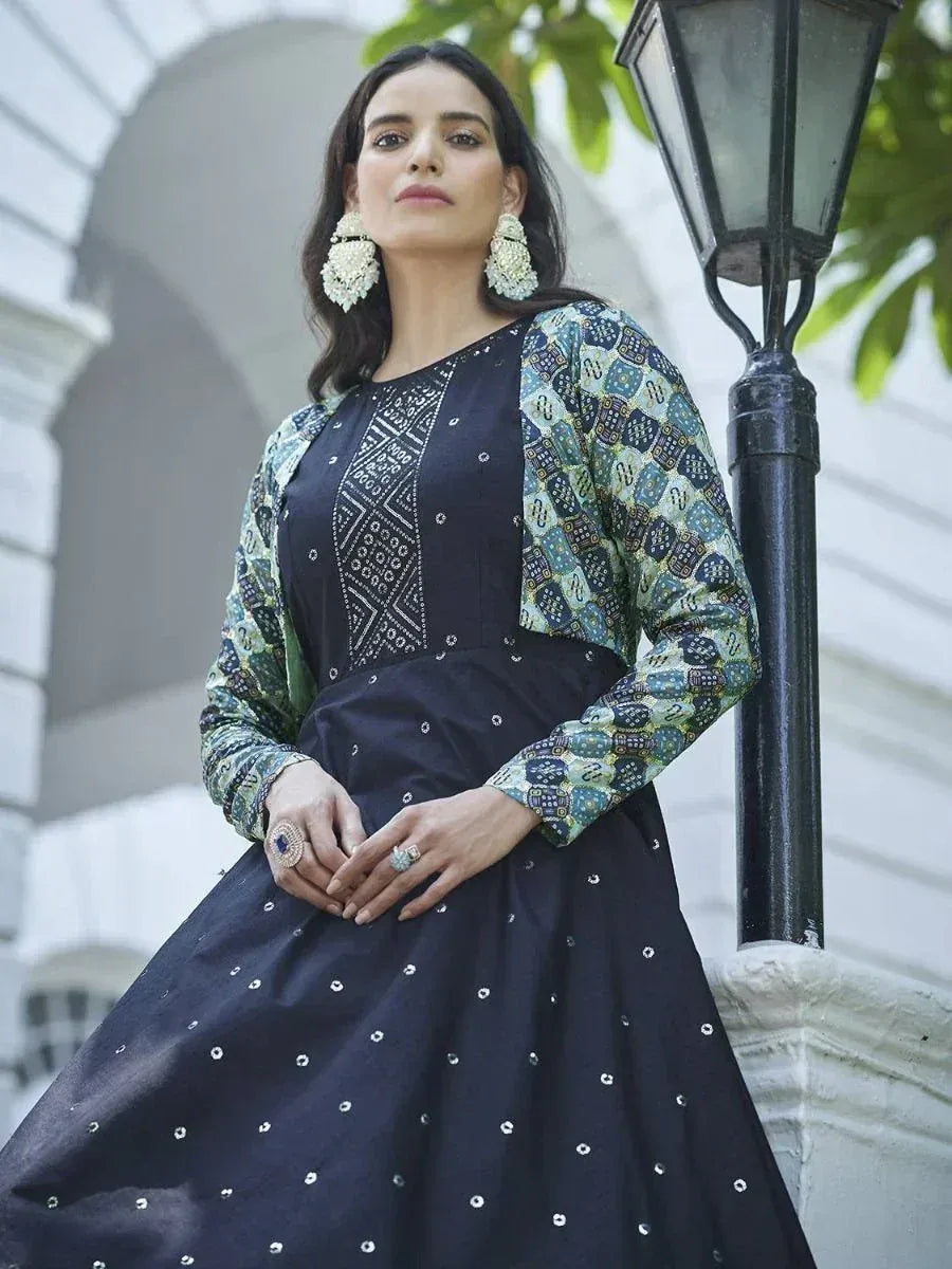 Woman in navy blue ethnic gown with printed sleeves, perfect for Indian festive occasions