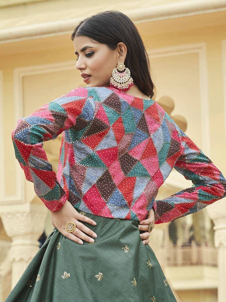 Colorful geometric print ethnic top with green embroidered skirt, styled with jhumka earrings