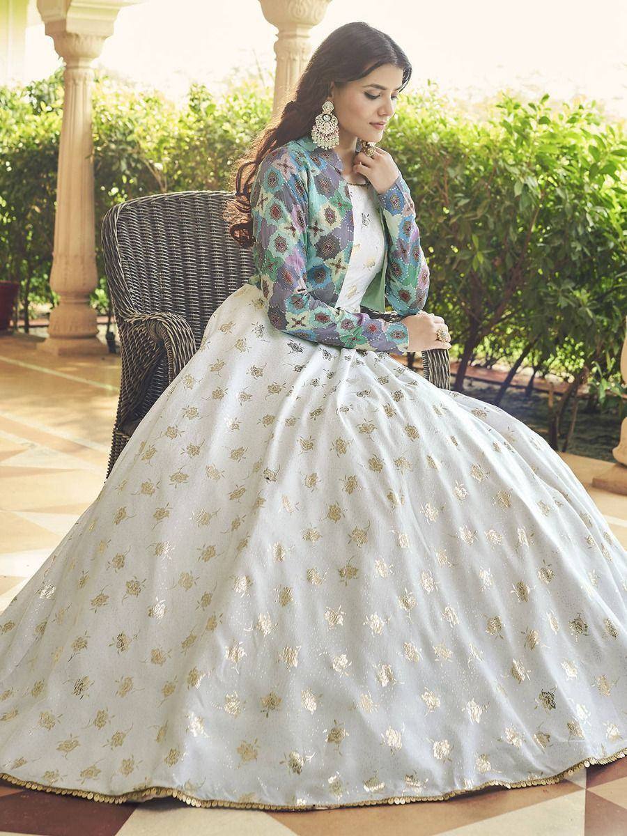 Elegant white lehenga with gold floral embroidery and colorful printed jacket, perfect for Indian ethnic occasions.