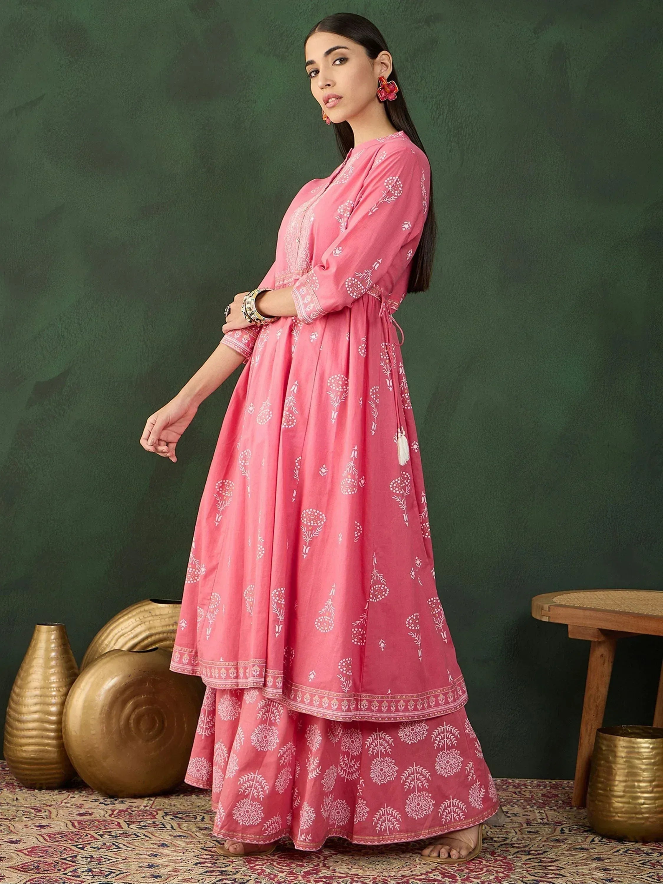Pink printed ethnic anarkali suit with white floral motifs, perfect for Indian occasions and festivals