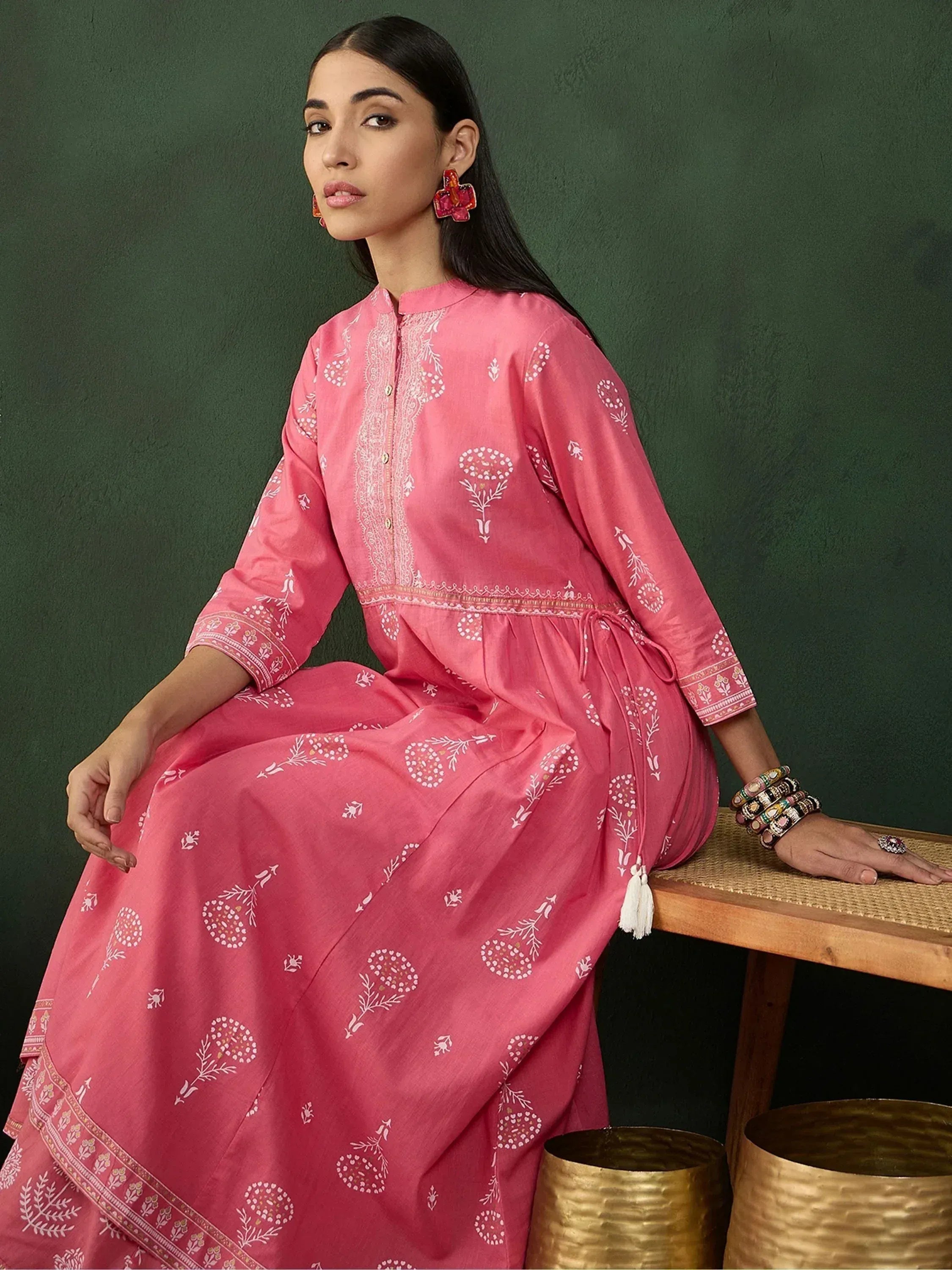 Pink floral printed ethnic gown with white embroidery, perfect for Indian occasions and festive wear.