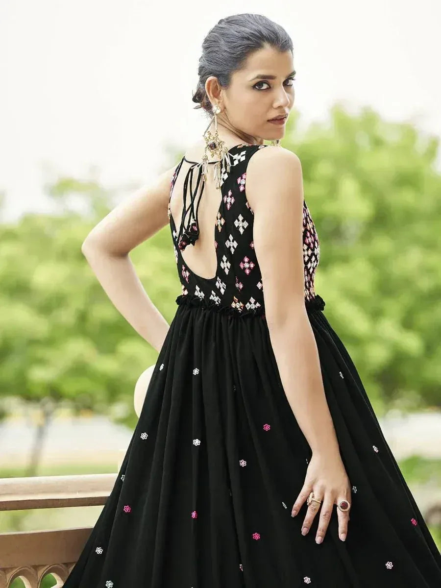 Black embroidered ethnic gown with back cutout and floral detailing, perfect for Indian occasions.