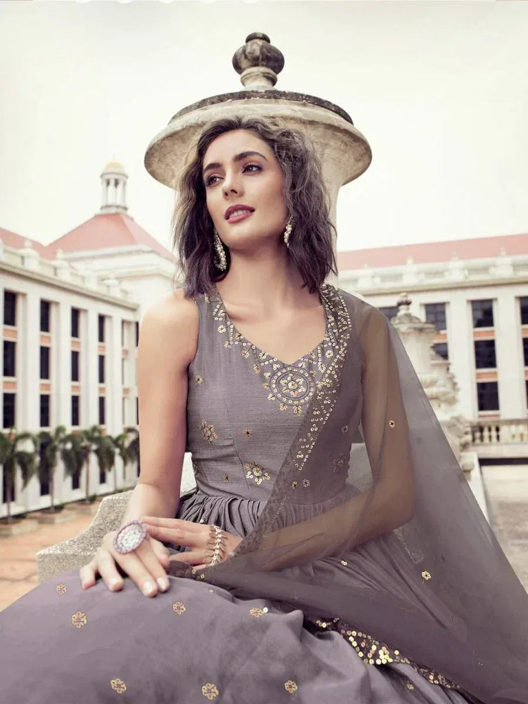 Grey embroidered ethnic gown with sheer dupatta, perfect for Indian weddings and festive occasions.