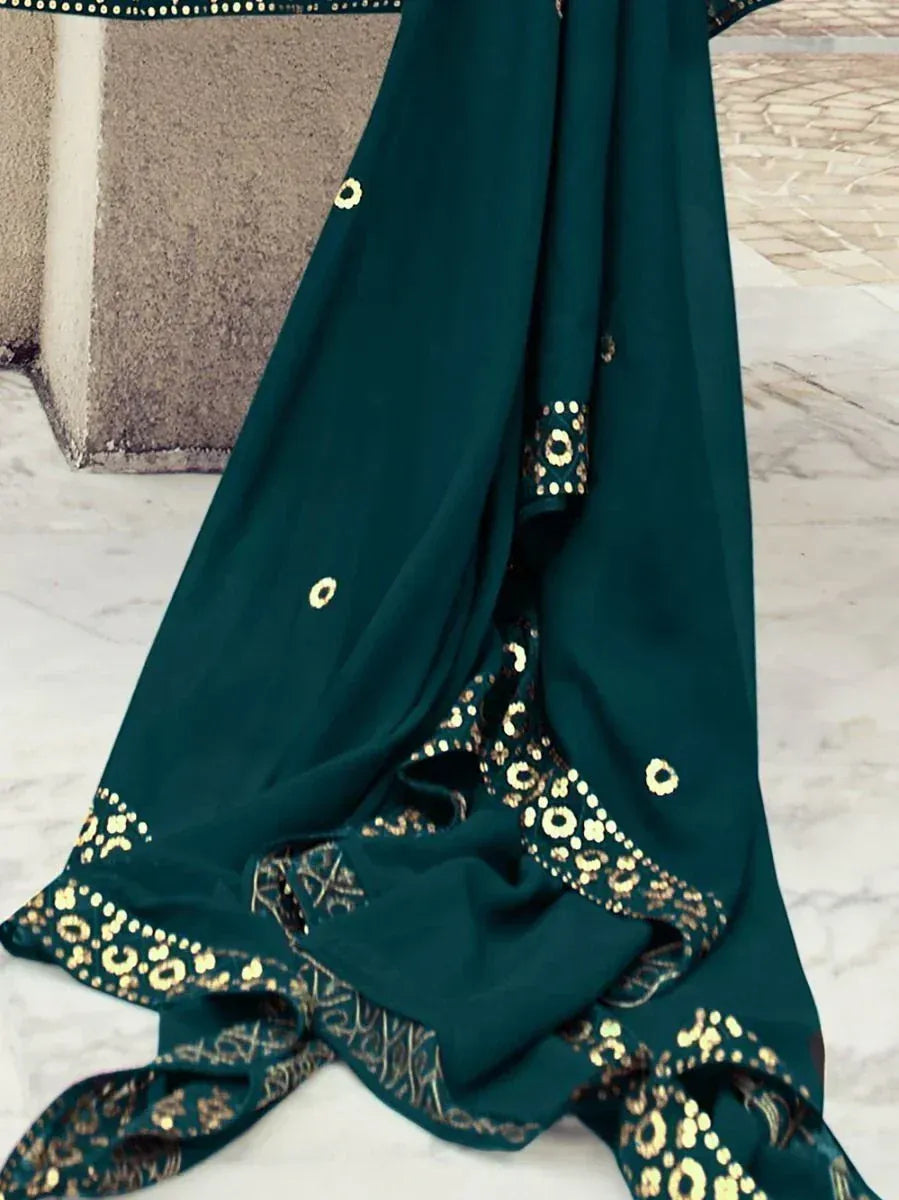 Emerald green ethnic gown with gold embroidery, perfect for Indian occasions and festive wear.