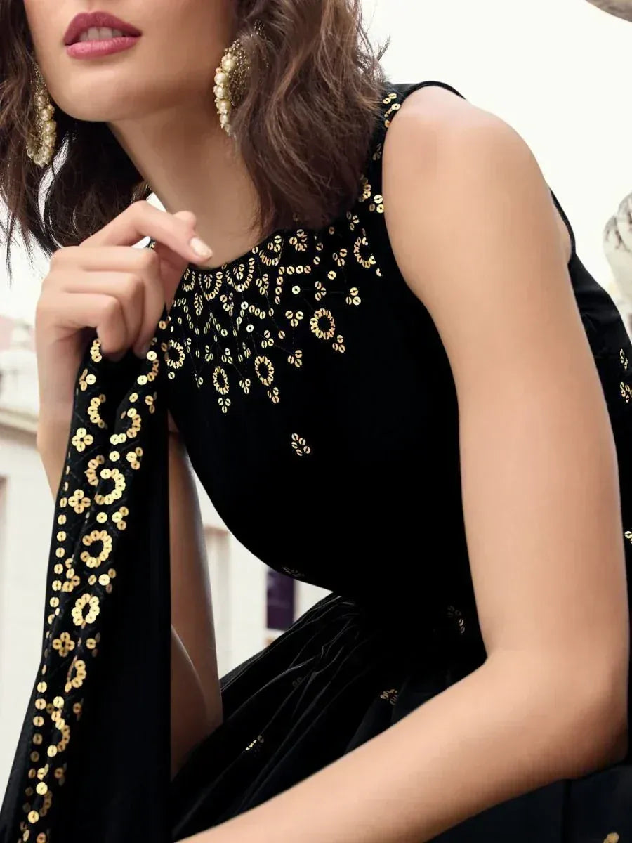 Black velvet ethnic gown with gold sequin embroidery, perfect for Indian festive occasions