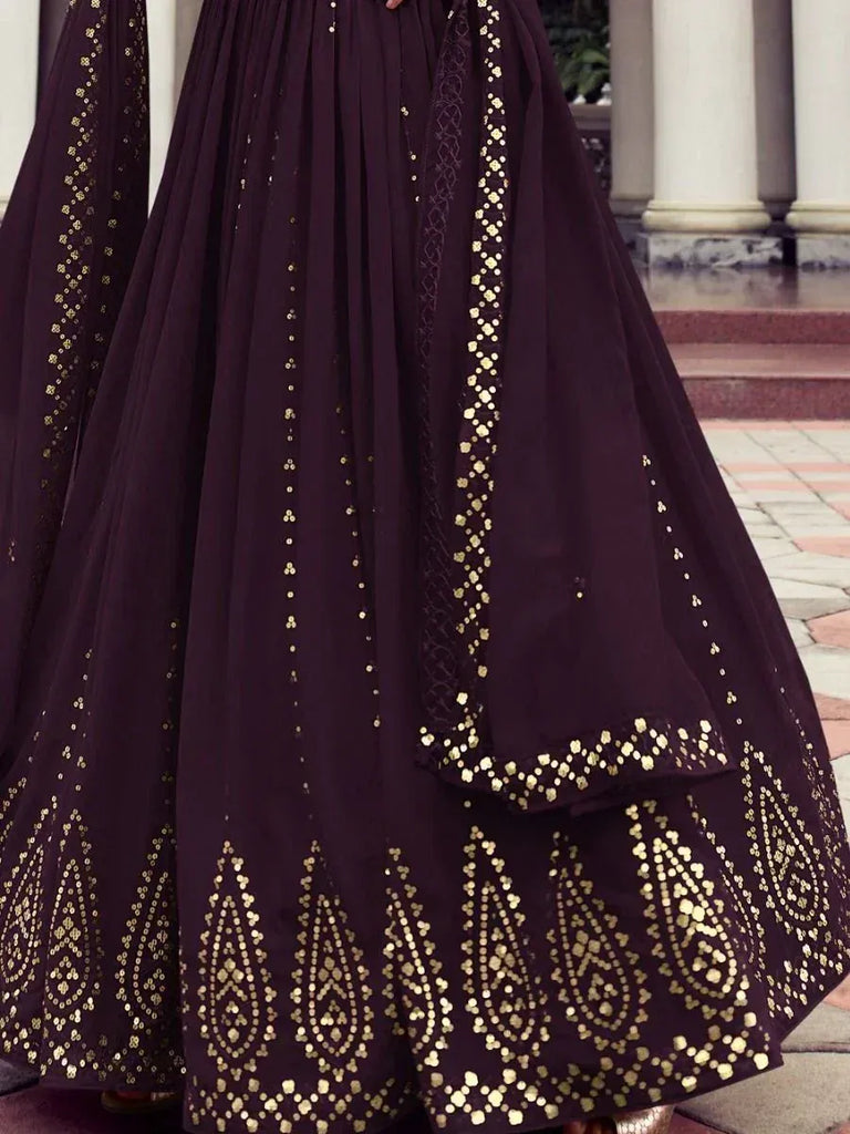 Dark purple lehenga with gold embroidery, perfect for Indian ethnic wear and festive occasions.